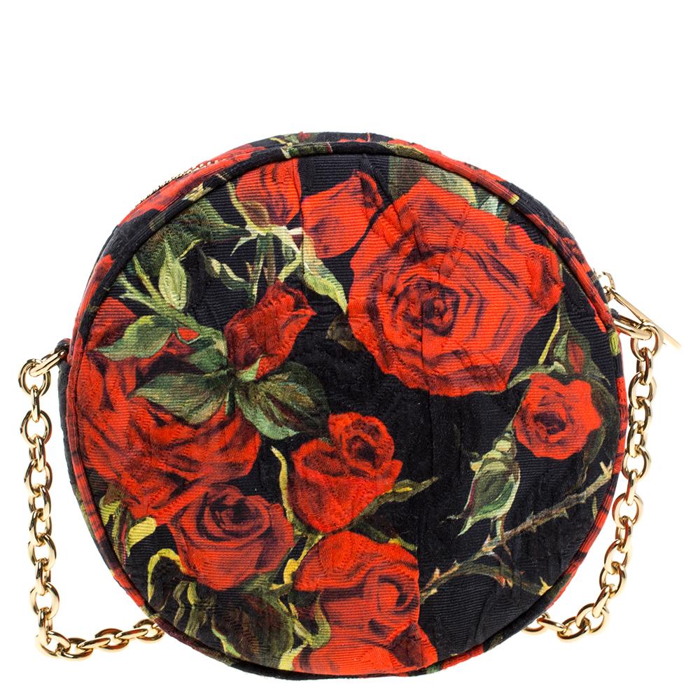 This exquisite Miss Glam round shaped bag from the fashion house of Dolce & Gabbana is a sure spotlight winner. It has been beautifully crafted in Italy and made from floral printed fabric. It features a gold-tone chain shoulder strap. The zipper