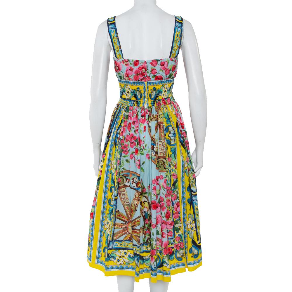 Dolce & Gabbana's beautifully printed cotton-poplin dress will effortlessly tap your playful and modern, feminine mood. It is designed in a fit and flare shape with a flattering neckline and smocked waist. Team yours with colorful flats and groovy