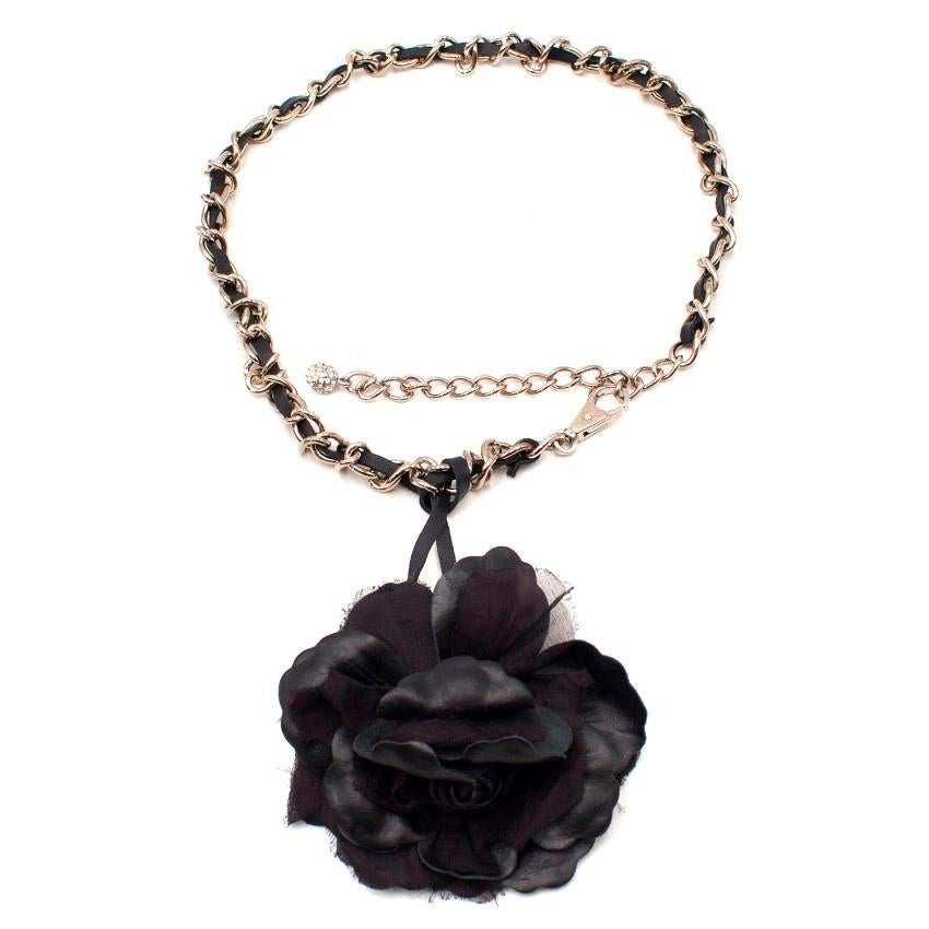 Dolce & Gabbana Chain Belt

- Silver-tone hardware
- Black leather woven through the chain
- Removable leather flower charm detail 
- Crystal charm to the end of the extender chain
- Dolce & Gabbana logo embossed on the clasp

Please note, these