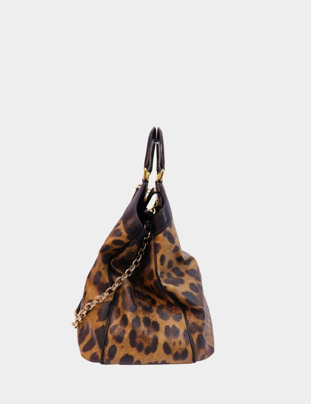 Make a bold statement with this Dolce & Gabbana Leopard Print Large Handle Bag, crafted in durable coated canvas with luxe leather trim. Featuring a spacious interior, sturdy top handles, and a shoulder strap with chain detailing, this bag blends
