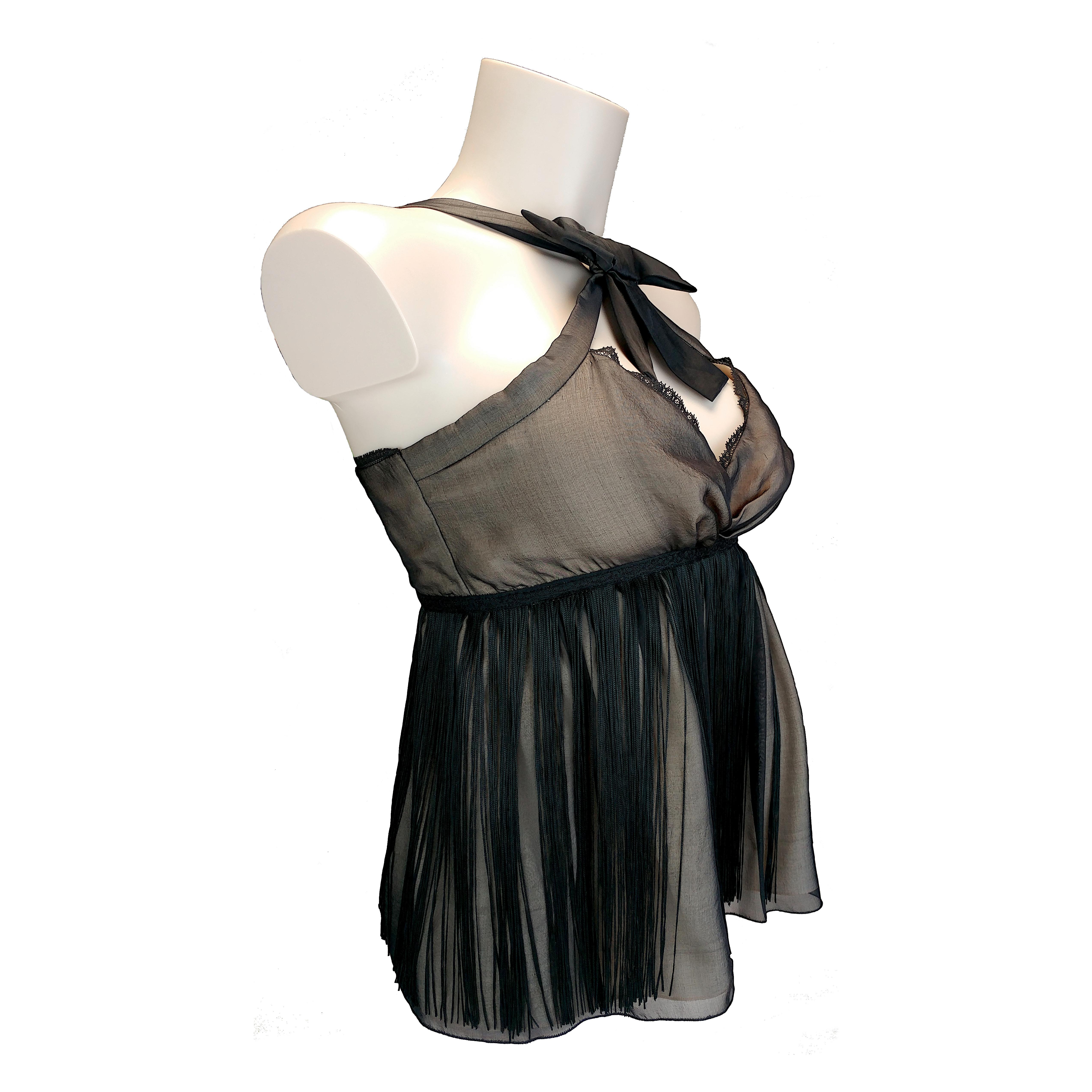 This is a fringed sleeveless top made of pure silk fabric from Dolce & Gabbana, labeled D&G. It is a new item never worn, still with its original price tag, seal and authenticity hologram. It features a rear zip closure and a bow standing on the