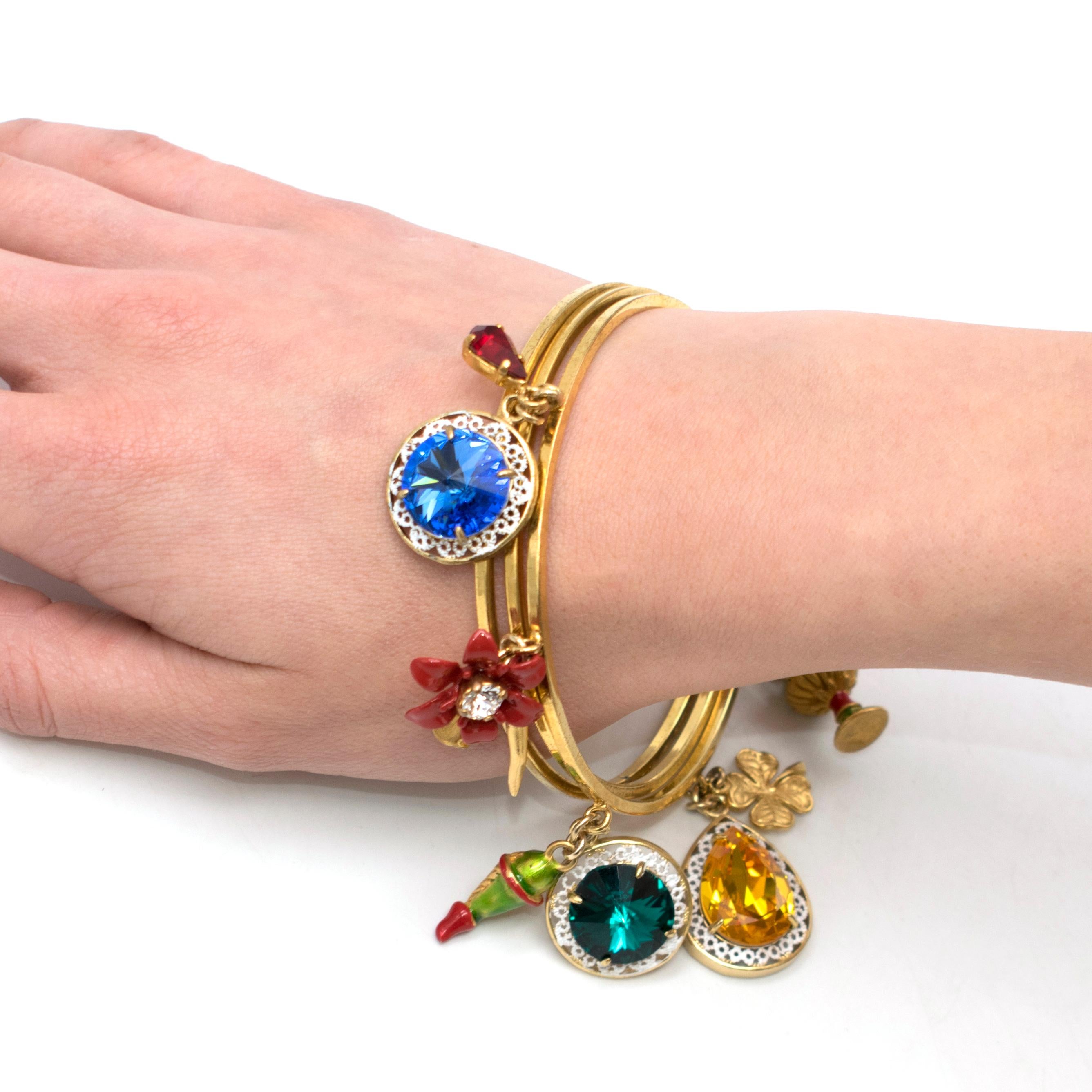 Dolce & Gabbana fruit-charm stacked bangle 

- Gold-tone brass
- Triple stacked polished bangles 
- Multicoloured resin and crystal encrusted multi-motif charms 

Please note, these items are pre-owned and may show some signs of storage, even when