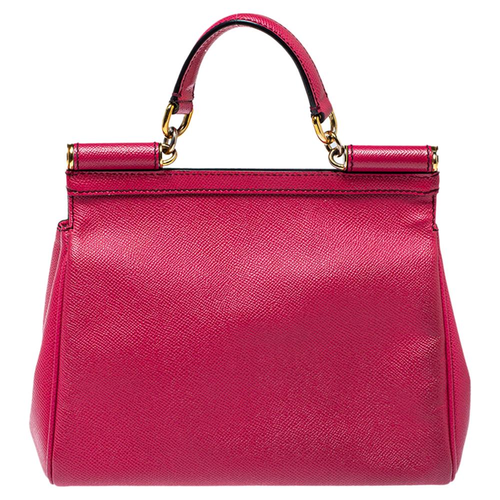 The iconic Miss Sicily bag by Dolce & Gabbana is named after Domenico Dolce's native land and exhibits the aesthetic of Italian glamour. The neat silhouette is made from leather in bright fuchsia and features a front flap accented with the signature