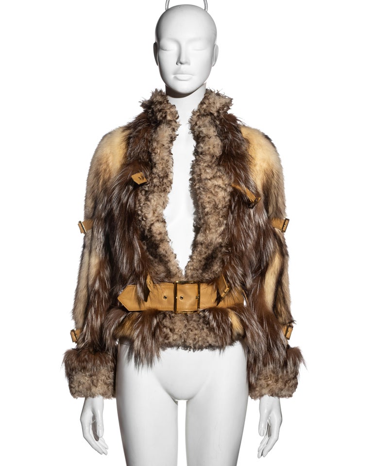 ▪ Dolce & Gabbana beige fur and shearling jacket 
▪ Multiple cream lambskin leather belts with gold buckles at the front, back and sleeves
▪ Fox and polecat fur with shearling cuffs and collar
▪ Red silk lining 
▪ Fall-Winter 2001