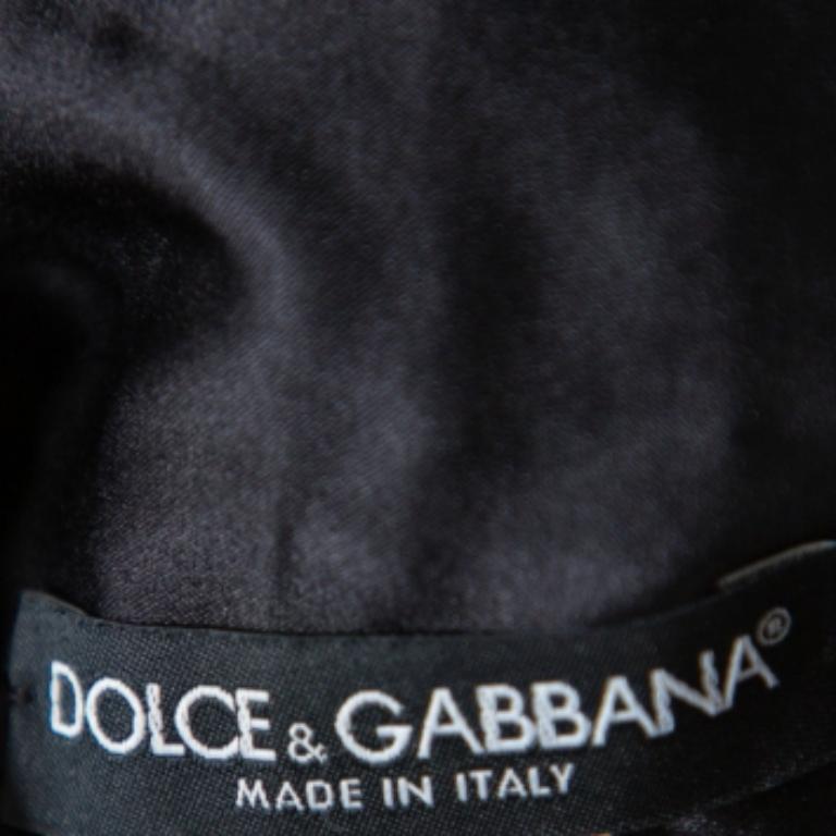 This Dolce & Gabbana camisole top brings a wonderful sight to one's eyes. It flaunts a sleeveless style with sequin paillette detailing all over. The fuchsia pink blouse is lovely and simply high-fashion.