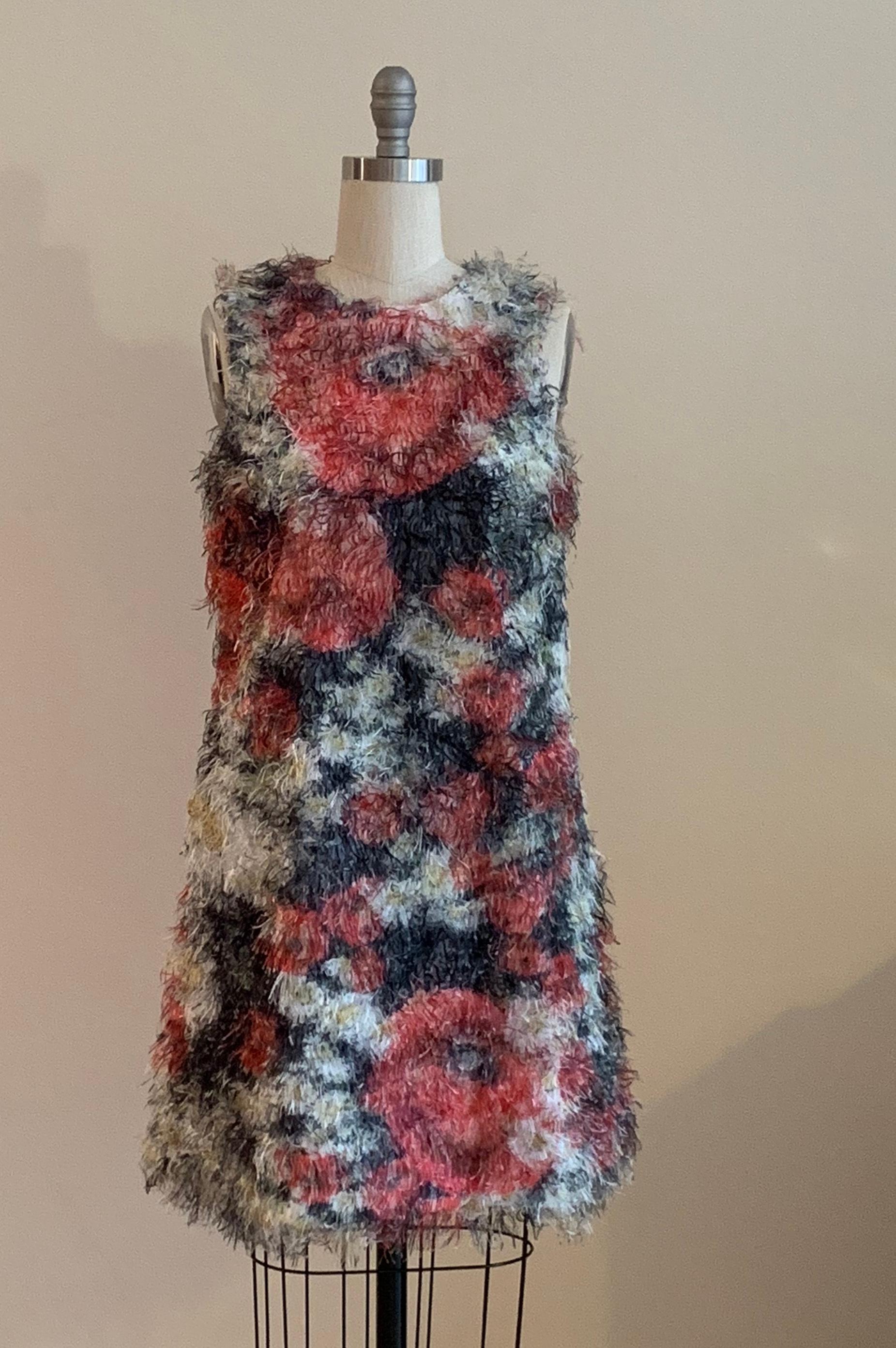 Amazing fuzzy statement dress from Dolce & Gabbana features red, yellow, white and green floral print covered all over in wild eyelash fringe. Floral lining. Back zip and hook and thread loop closure.  

100% polyester. Fully lined in 96% silk, 4%