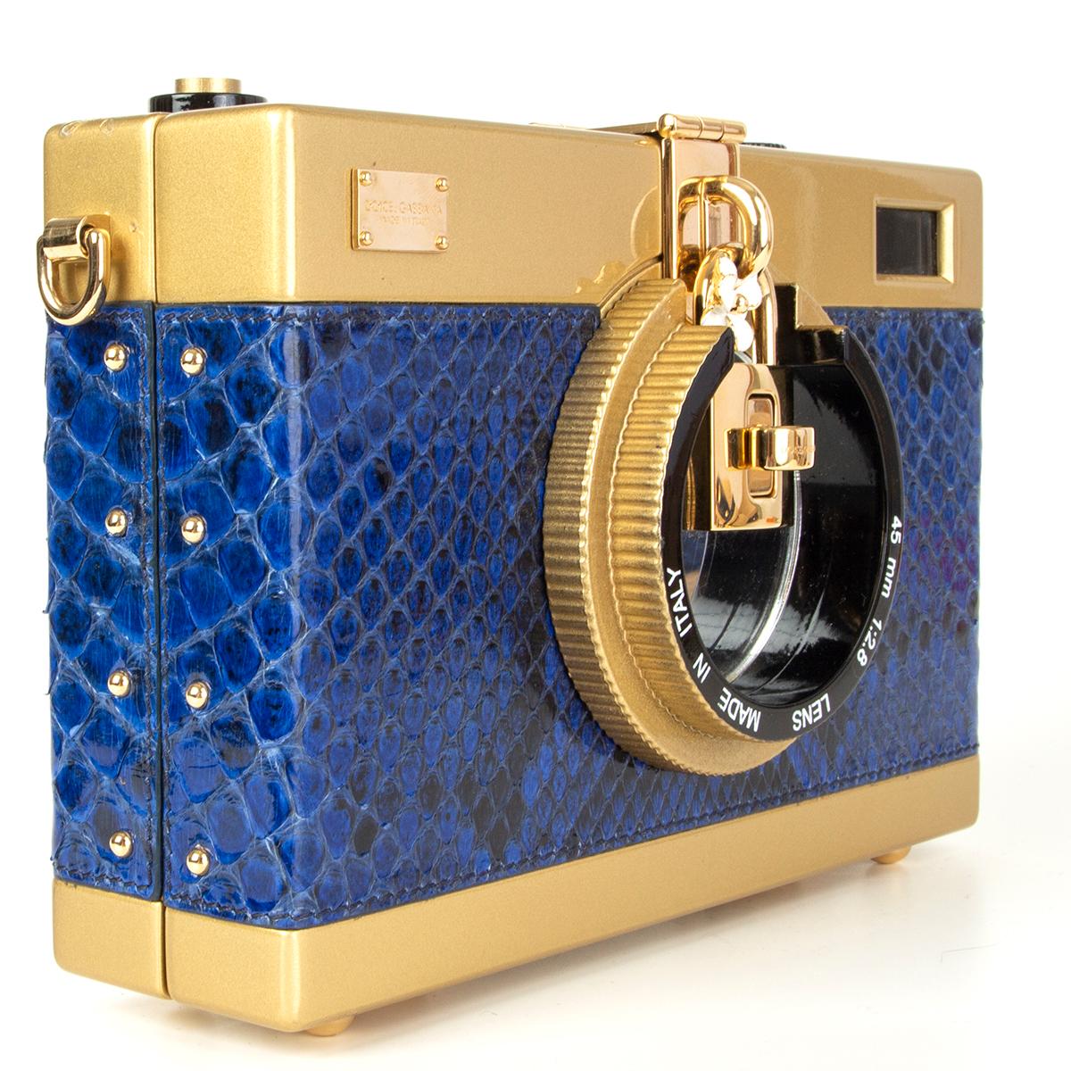 Dolce & Gabbana 'Camera Case' shoulder bag in royal blue python and gold-tone acetate featuring detachable python/canvas shoulder strap. Opesn with a turn-lock on the lens and is lined in black satin with one open pocket against the front. Has been