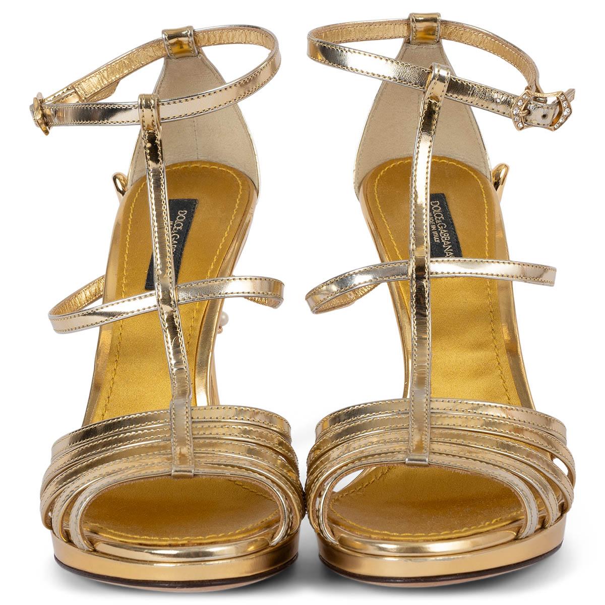 100% authentic Dolce & Gabbana gold patent leather t-strap sandals with gold-tone hardware, gold acetate 