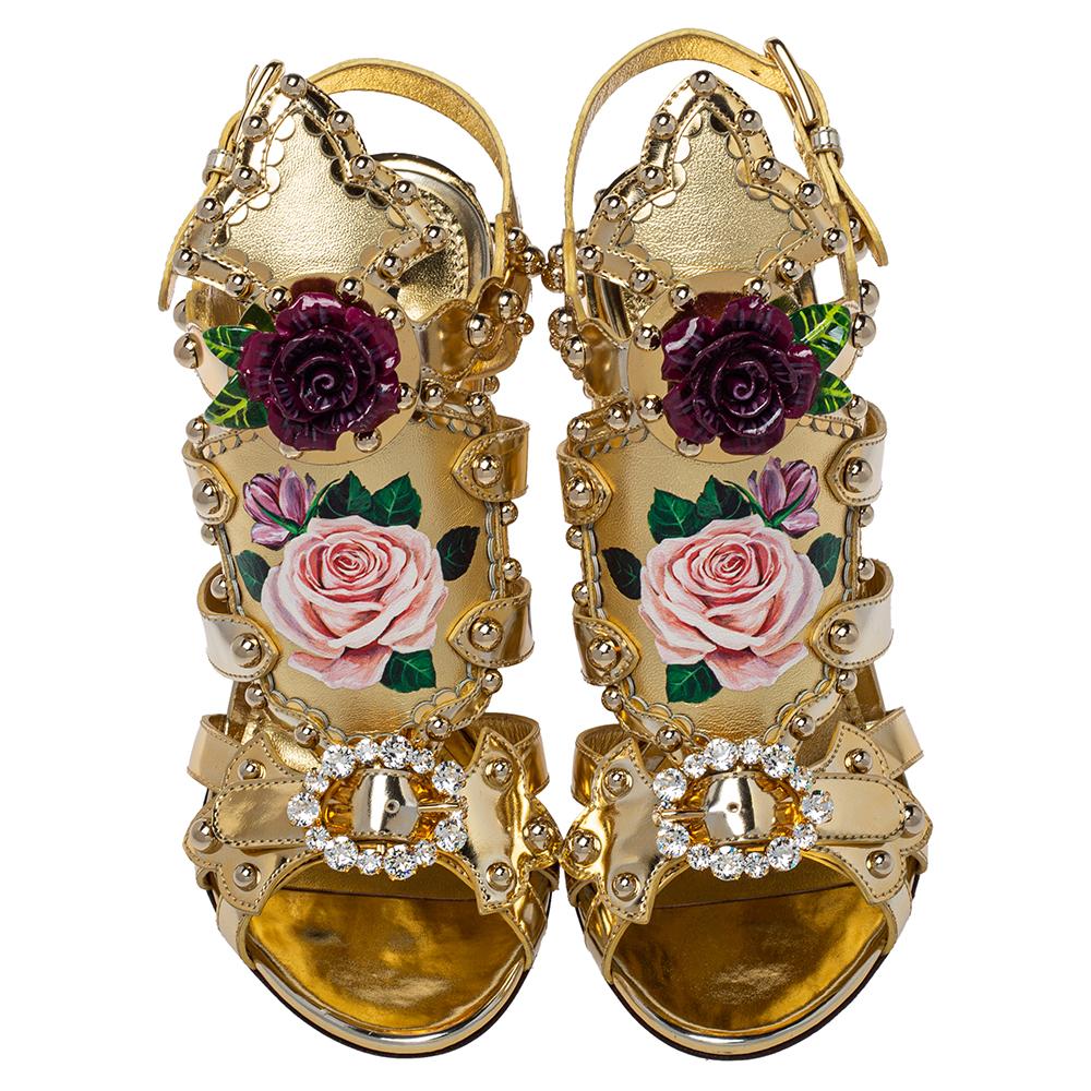 Delivering on the signature romantic aesthetic through flowers, the Mordore sandals by Dolce & Gabbana are a sight to behold. They are secured with gold leather straps, lifted on block heels, and amplified with painted details, crystals, studs, and