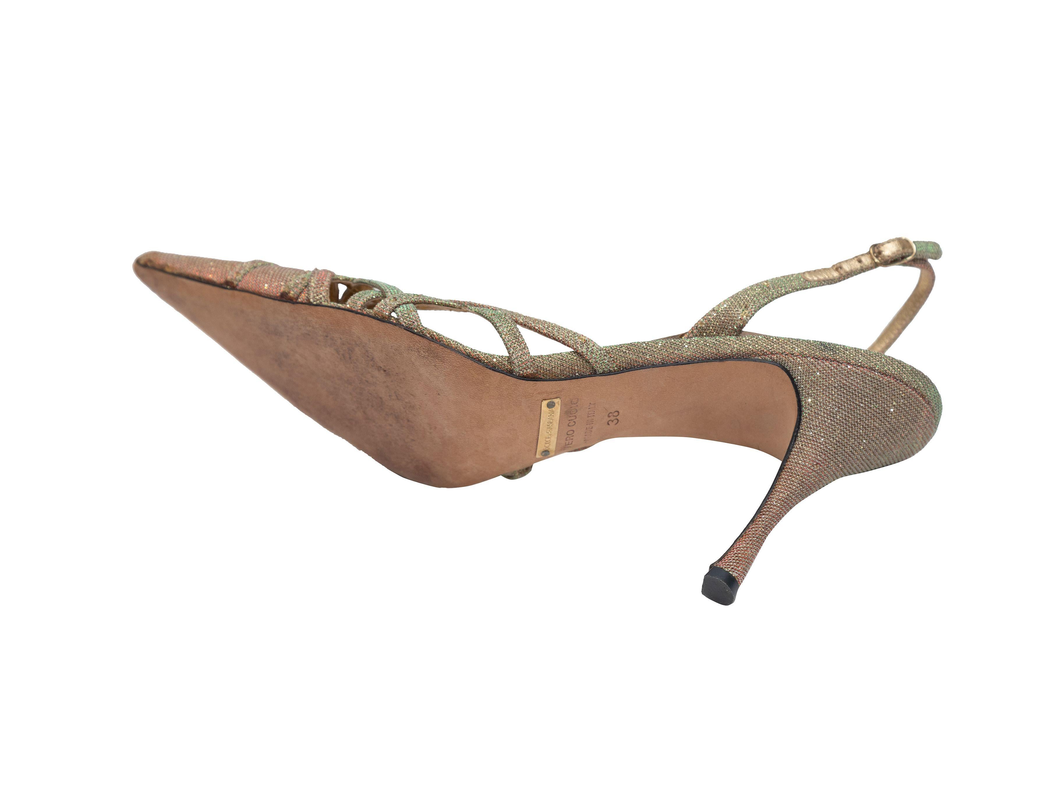 Product Details: Gold metallic lamé pointed-toe slingbacks by Dolce & Gabbana. Cutout detailing at toes. Buckle closures at slingback straps. 3