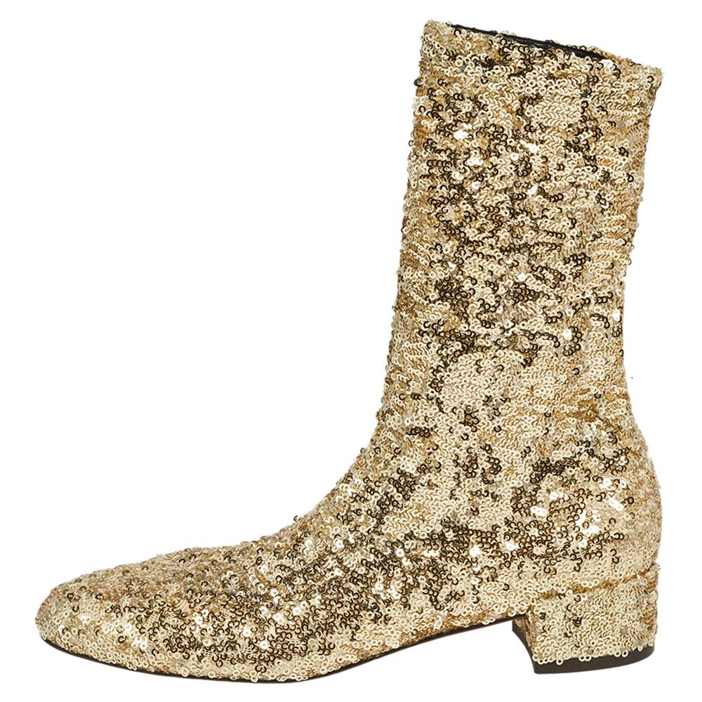 These glamorous boots from Dolce & Gabbana will add glitz and charm to your ensemble. These mid-calf boots are carved using gold sequins on the exterior, granting them a rather extraordinary appearance. They are completed with 3 cm heels. Flaunt