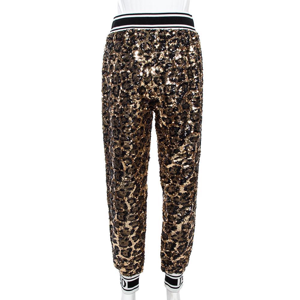 These Dolce & Gabbana track trousers are perfect for a high-fashion look. Knit in quality materials, the creation features sequin embellishments all over, brand label printed waistband, and comfortable wearing experience.

