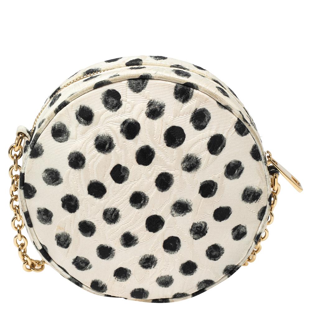 This chic crossbody by Dolce and Gabbana lives up to its name. Its small size is coupled with a gold-tone brand plaque, a chain-link shoulder strap, and a graphic polka dot design in black and white. The exterior and interior of the bag are made
