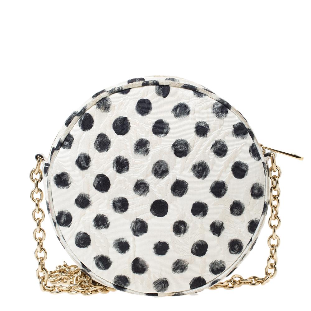 Dolce & Gabbana's crossbody bag is an opulent style for all occasions. Designed in a round shape with polka dots all over, it has a top zipper that opens to reveal an interior with enough room for your essentials. Carry it to instantly put a