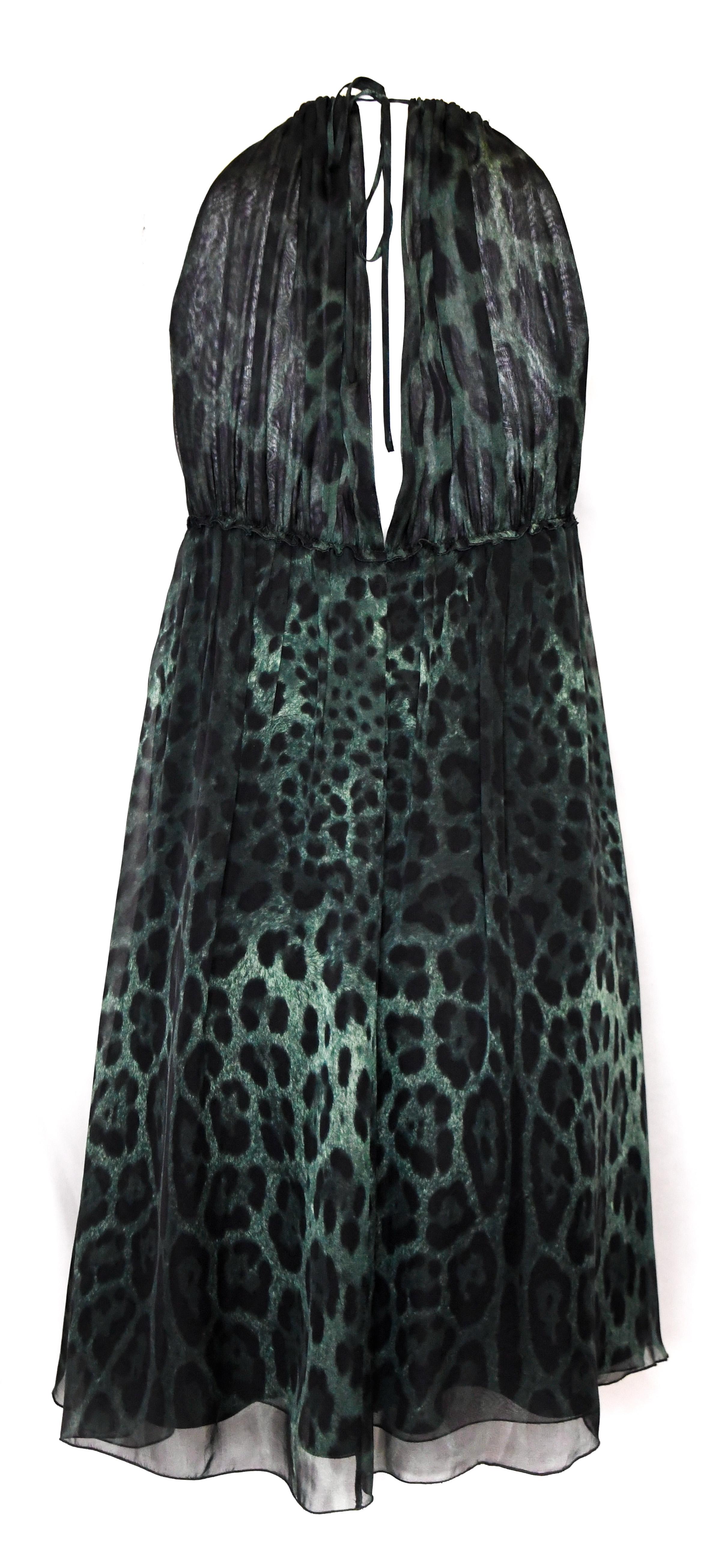 Dolce & Gabbana green and black silk leopard print dress is romantic and diaphanous with just the right amount of animal magnetism.  Features signature leopard print silk in envy green.  Front and back are expertly gathered at neckline. 
Front
