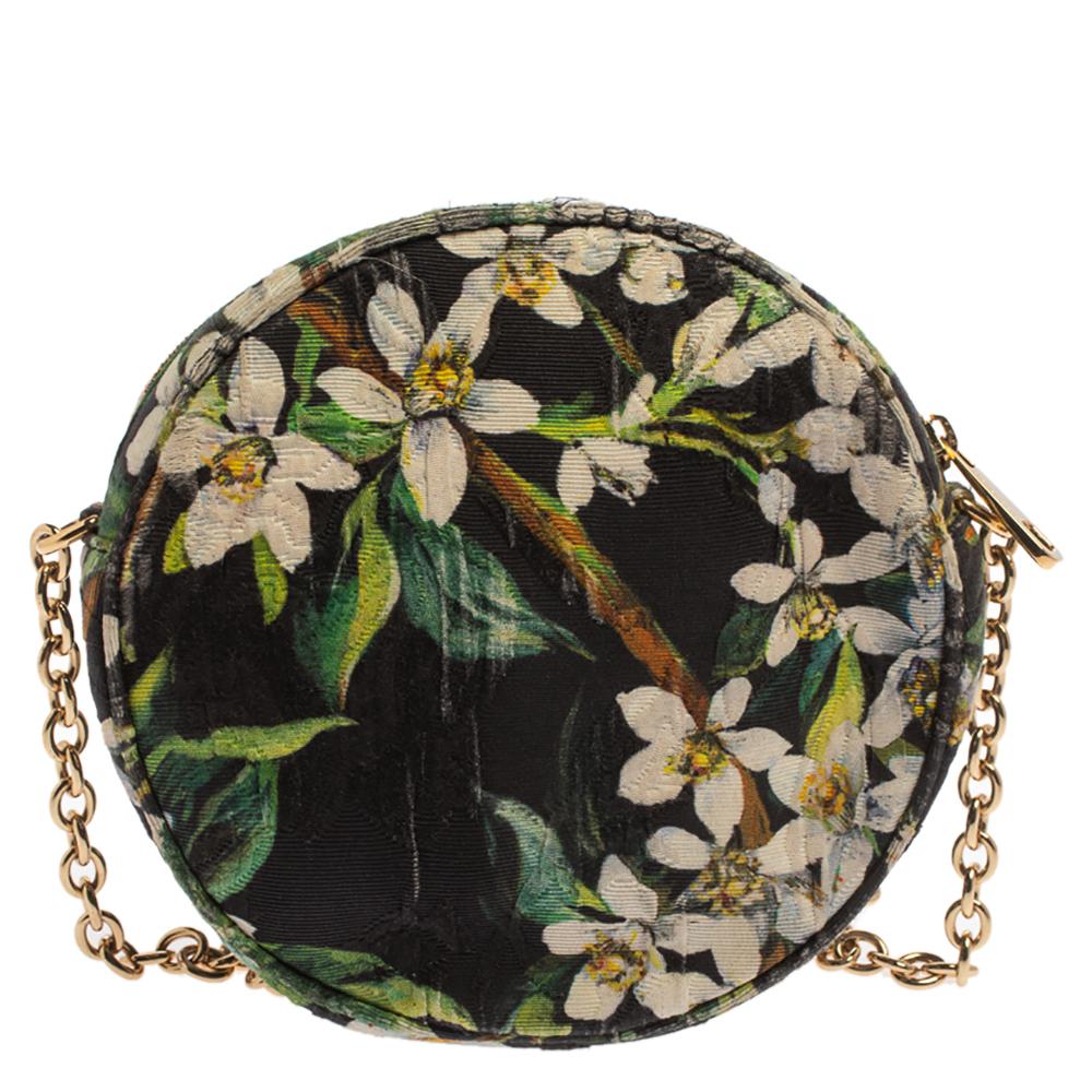 This exquisite Miss Glam round-shaped bag from the fashion house of Dolce & Gabbana is a sure spotlight winner. It has been beautifully crafted in Italy and made from floral printed fabric. It features a gold-tone chain shoulder strap. The zipper