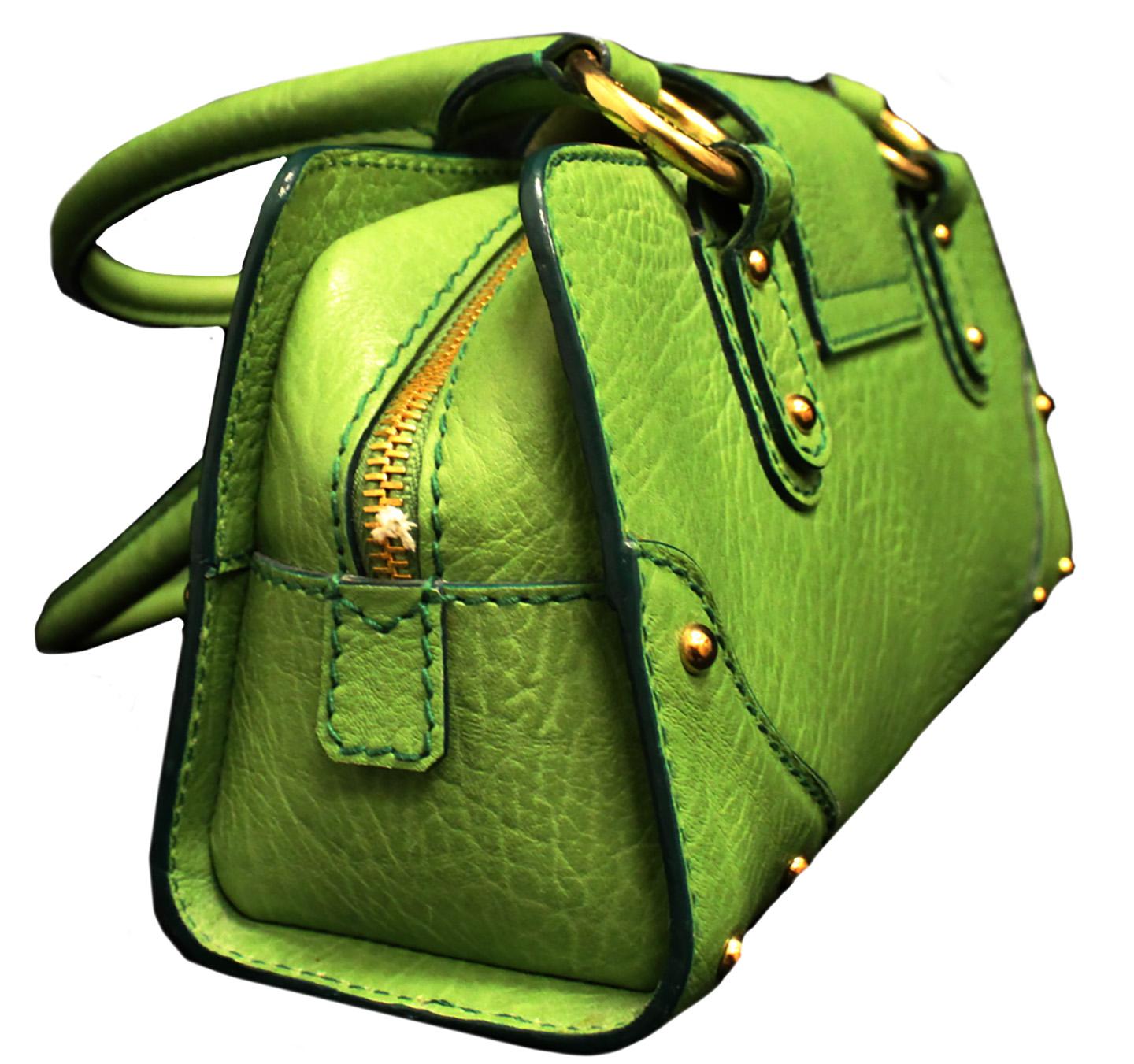 Dolce & Gabbana green grain leather bag includes two top handles with 7 inch drop that accommodates comfortably under your shoulder.  This bag is decorated with green top stitches throughout emphasizing the corner protectors, rolled leather top