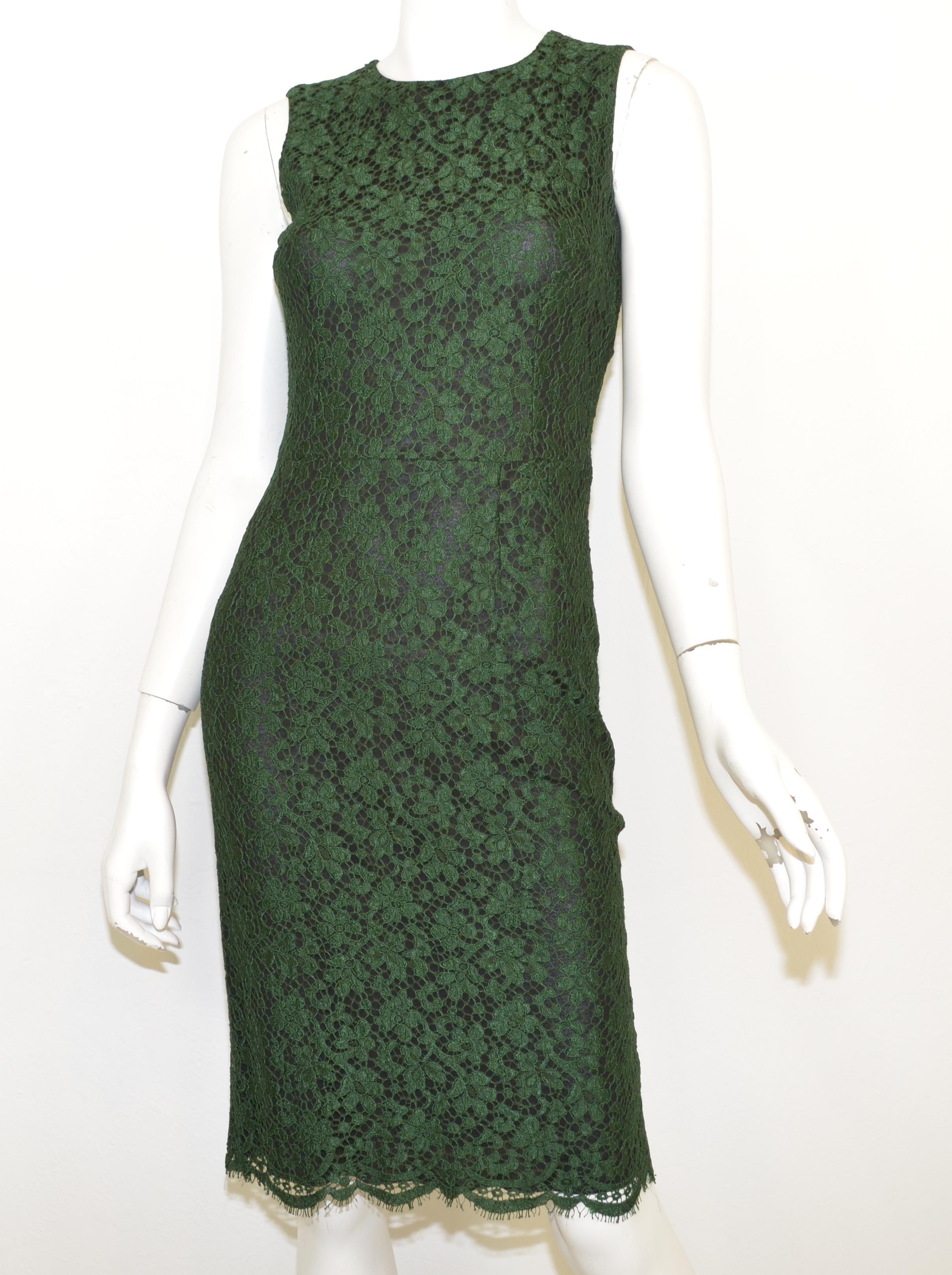 Dolce & Gabbana dress is featured in a deep green lace overlay with a black shell, back zipper fastening, and a scalloped hem. Dress is a size 38, made in Italy, composed with a cotton and nylon blend with a rayon shell.

Measurements:
Bust 32'',