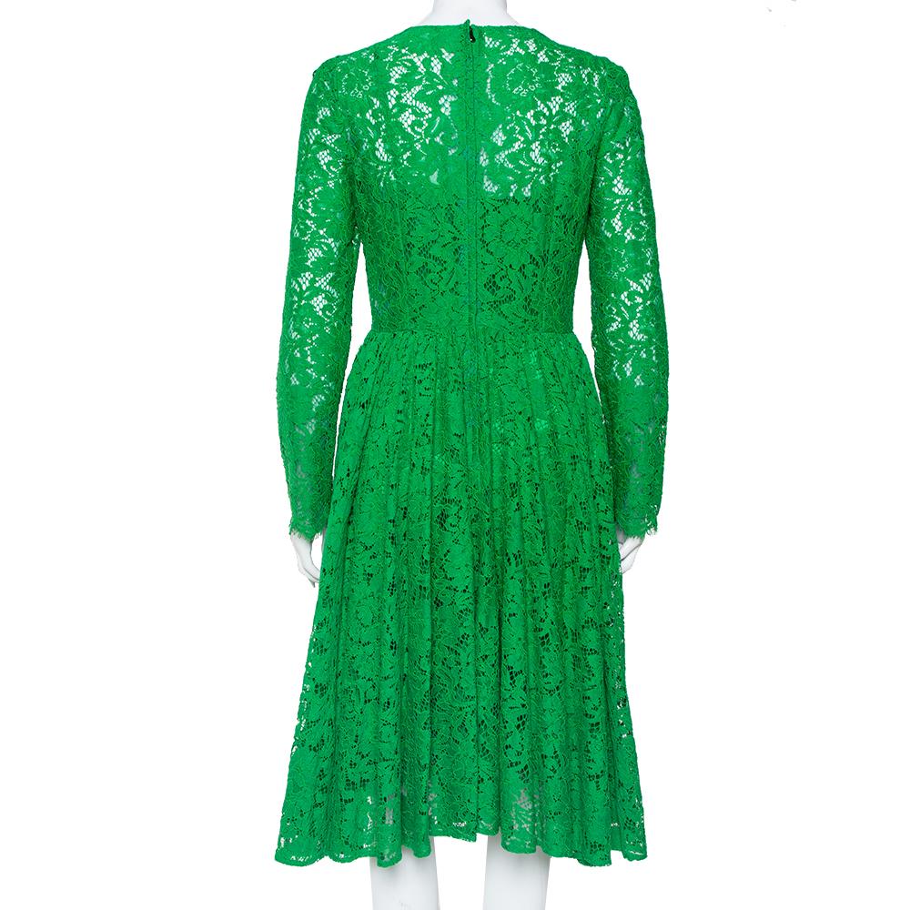 There is nothing more than lace that signifies femininity, just like this stunning Dolce & Gabbana dress. Designed in a green shade, the creation has a fitted bodice, a flared skirt, and full sleeves. Style the dress with a box clutch and a classic