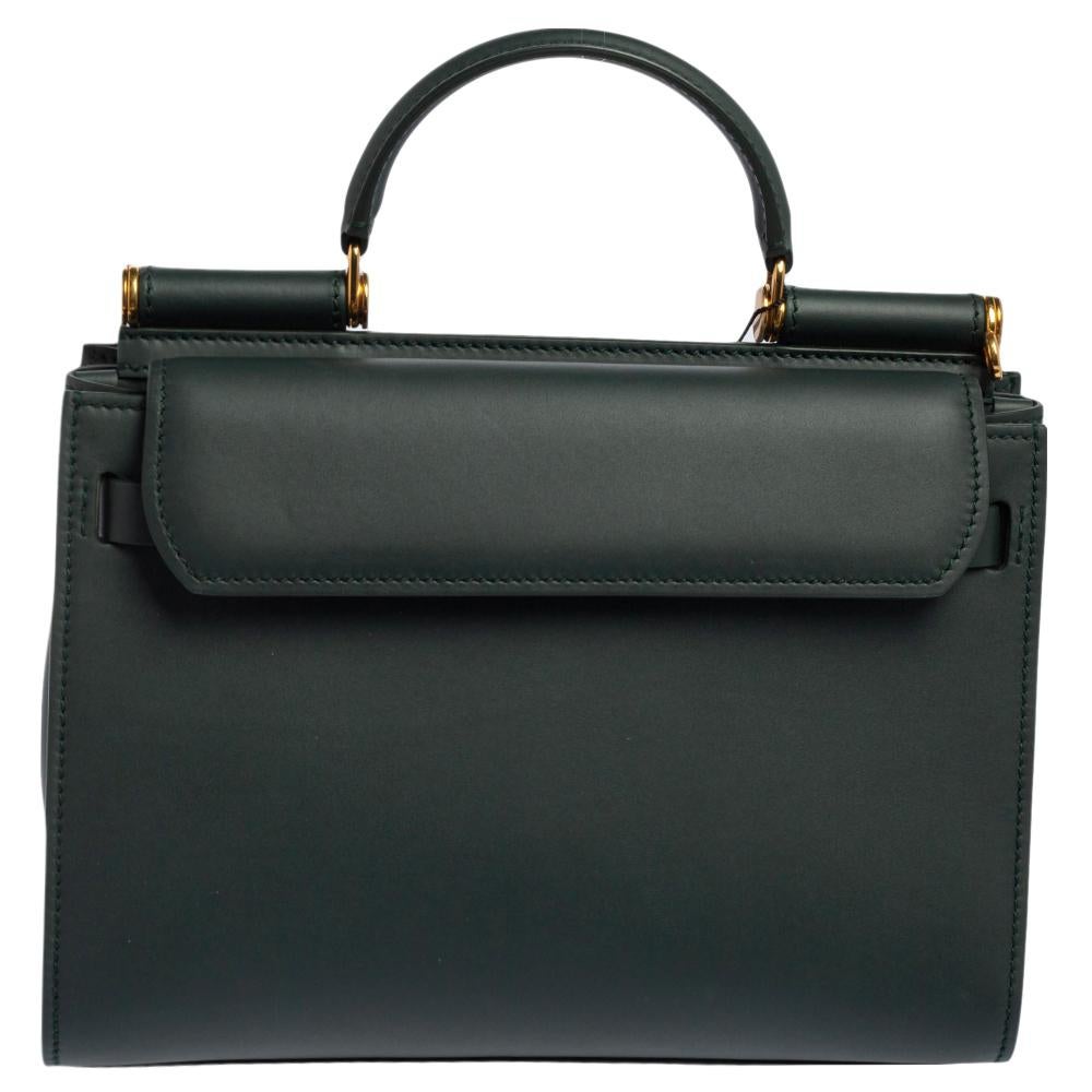 Make an exquisite appearance every time you carry this ageless Sicily 62 bag by Dolce & Gabbana. A green-hued bag like this is hand-picked to make you look your best. This leather bag has a top handle, a front flap, a shoulder strap and a spacious