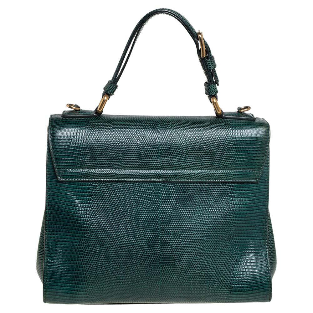 Well-structured and high on style, this Miss Monica bag from Dolce & Gabbana deserves to be yours! It has been crafted from lizard-embossed leather and styled with a top handle. It also comes with a gold-tone latch-lock flap that reveals insides
