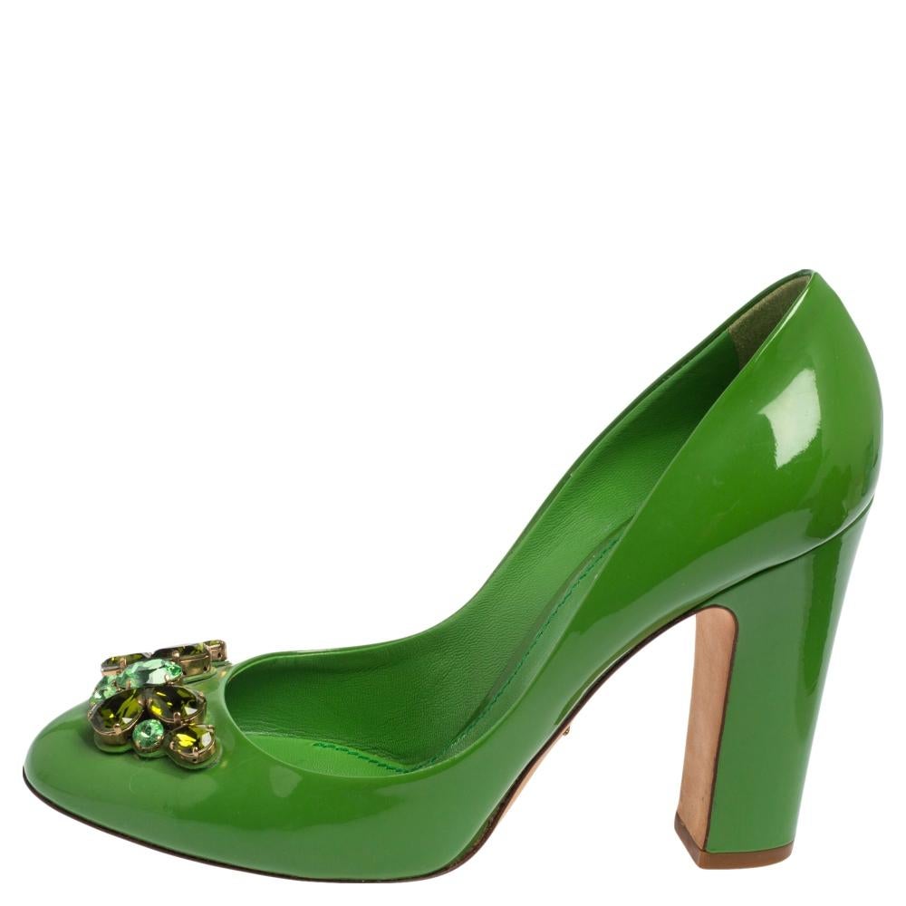 Exhibiting elegance in every way, these pumps by Dolce & Gabbana are worthy additions. Beautifully designed with green patent leather, these pumps flaunt rounded toes, 11 cm heels, and delicate crystal embellishments on the uppers. Spruce up your