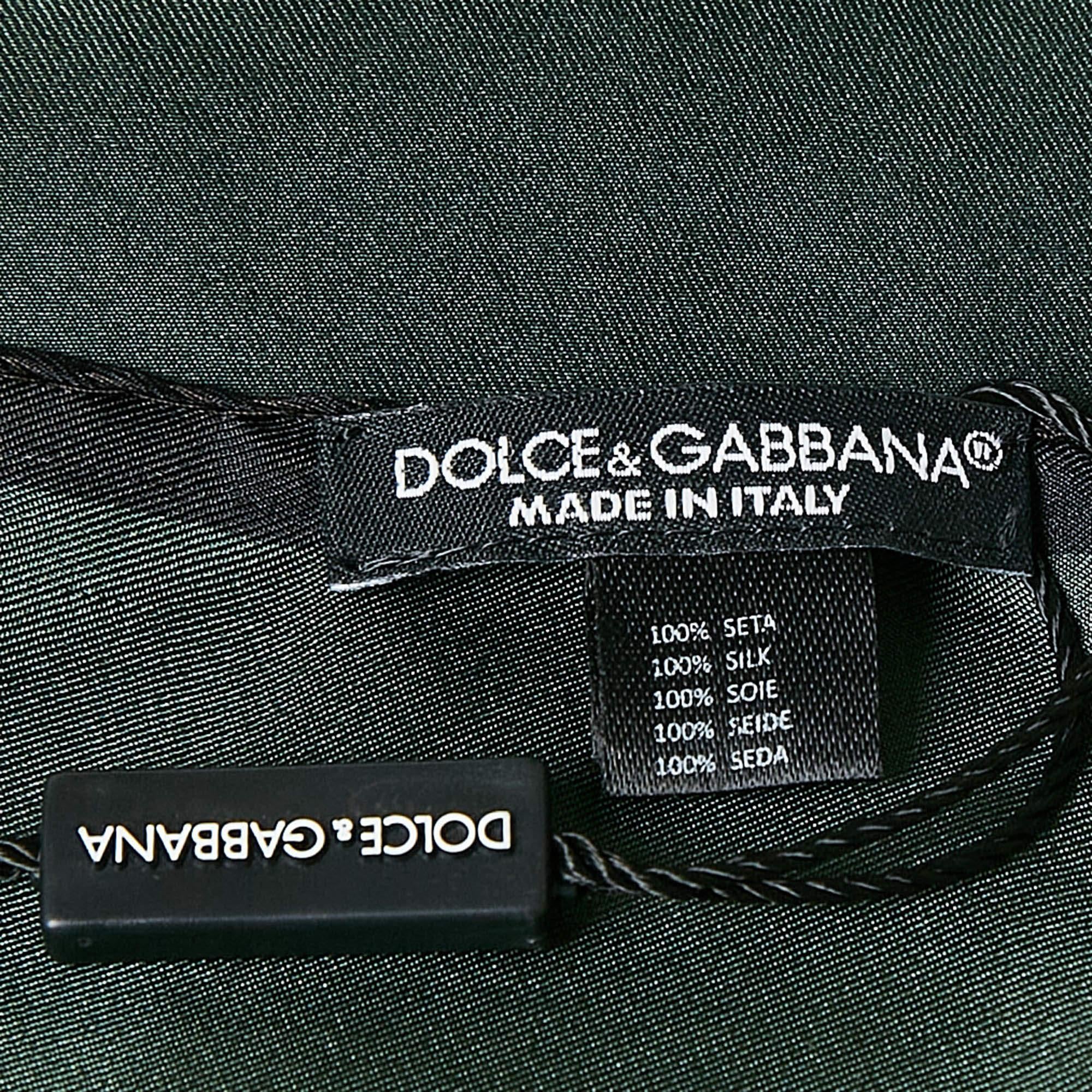 Crafted from luxurious silk this Dolce and Gabbana pocket square showcases a rich green hue adding a refined touch to any suit or blazer. The smooth texture and elegant finish make it a versatile accessory perfect for formal or casual ensembles. An