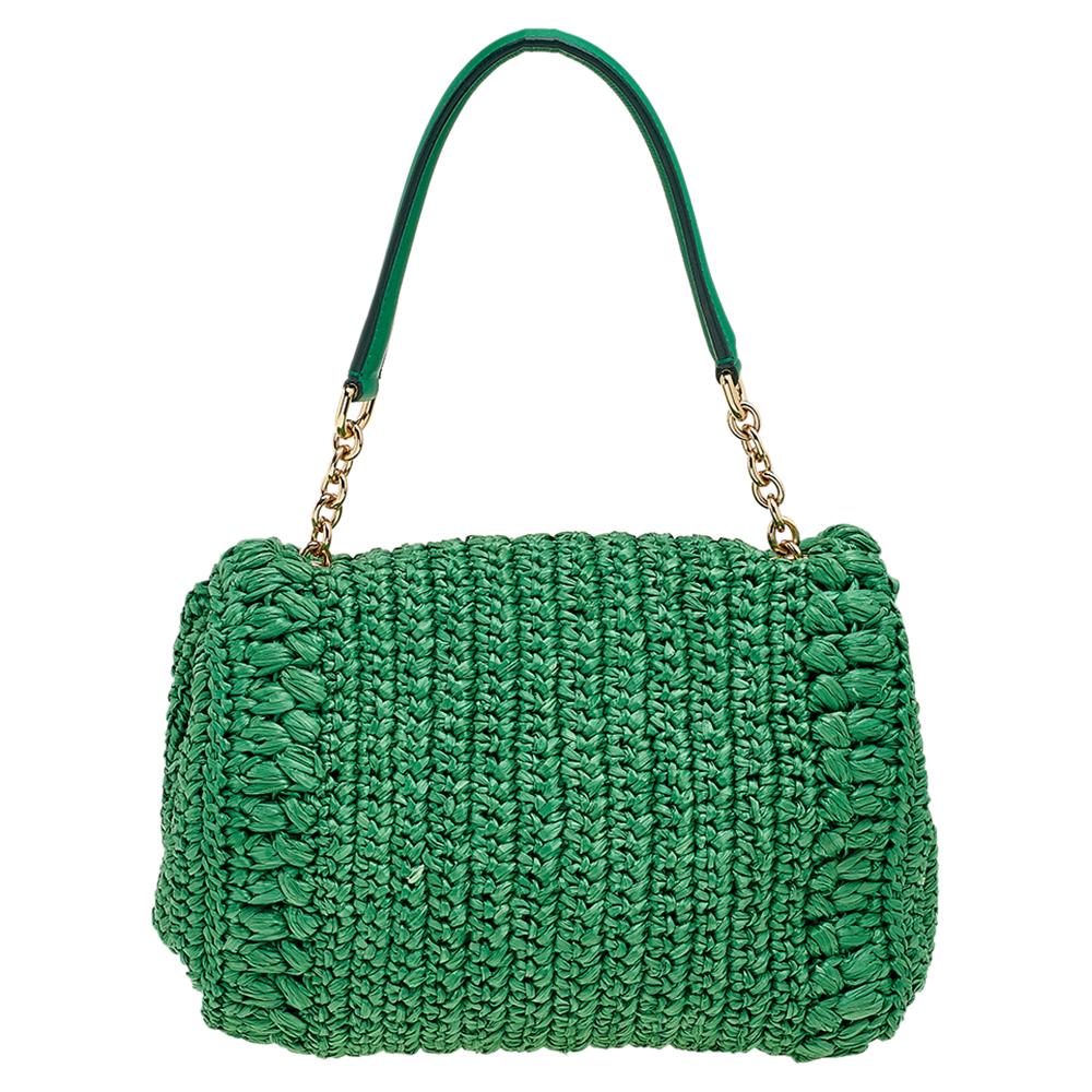 Dolce & Gabbana handbags are known for their unique designs that emanate the label's feminine verve and immaculate craftsmanship to last season after season. Crafted from straw in a green shade, this Miss Bonita bag comes with crystals on the front,