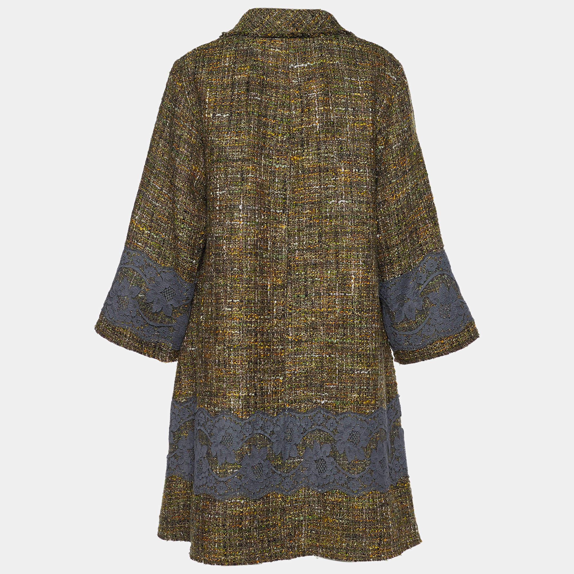 Make a practical investment in luxury fashion with this coat from the House of Dolce & Gabbana. It is tailored using green tweed fabric, which is augmented with lace appliques. It is provided with long sleeves, buttoned closures, and two pockets.