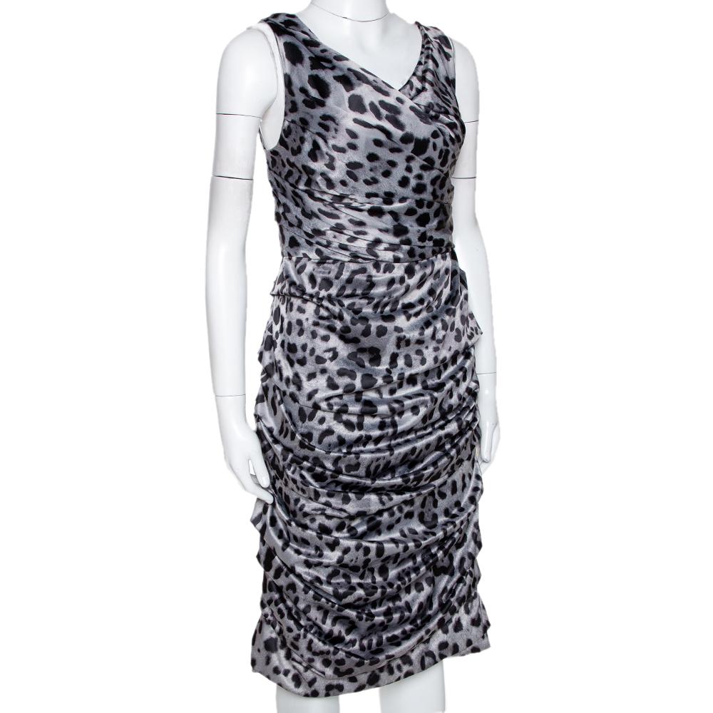 Dress to impress with this Dolce & Gabbana dress. It is crafted from a silk-blend and comes in a lovely shade of grey. It flaunts an animal print that is very flattering. This sleeveless dress has a ruched style, zip closure, deep back and a stylish