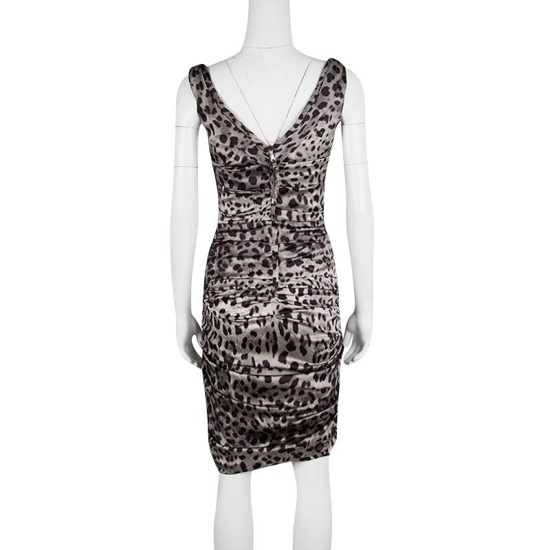 Dress to impress all around you with the animal inside of you with the Dolce and Gabbana Grey Animal Print Silk Ruched Sleeveless Dress. This silk dress has a square neckline on the front with a deep V at the back showcasing the asymmetry that is