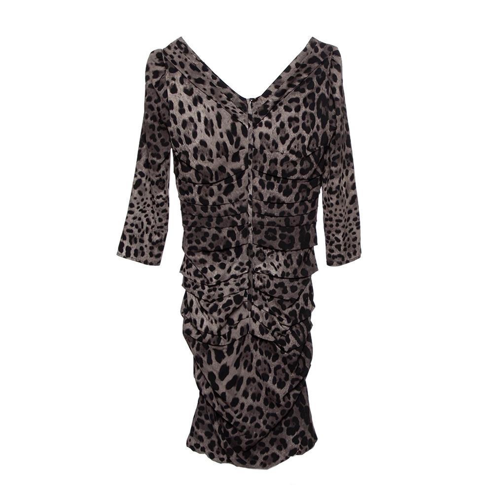 Dress to impress with this Dolce & Gabbana dress. It is crafted from a silk blend and comes in a lovely shade of grey. It flaunts an animal print that is very flattering. This dress has a ruched style, zip closure, and a stylish neckline. Pair with