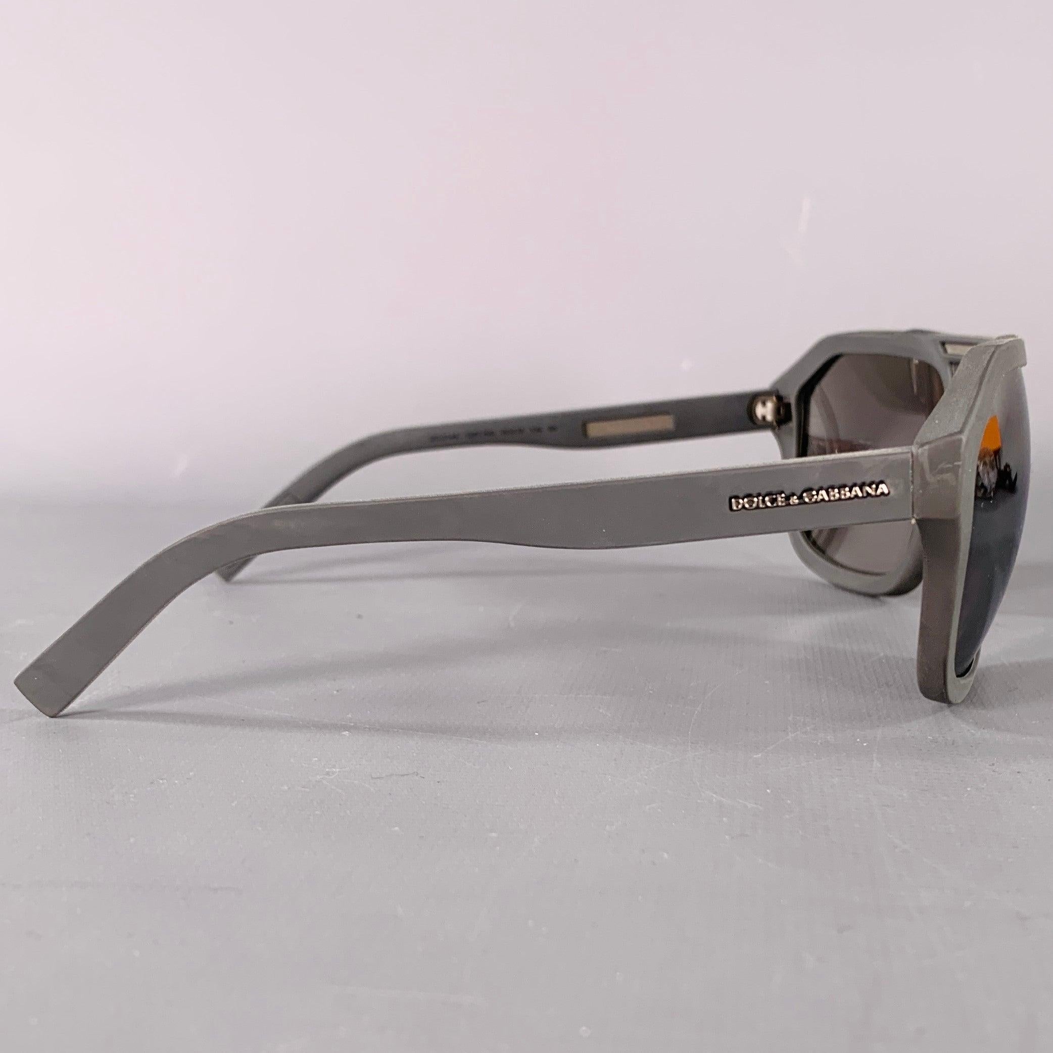 DOLCE & GABBANA sunglasses
in a charcoal grey rubber featuring a wide aviator style, and mirror lenses. Comes with case and box. Made in Italy.New with Box. 

Marked:   DG2146 1267/6G 

Measurements: 
  Frame Width: 14.5 cm.Frame Height: 5 cm.
  
 