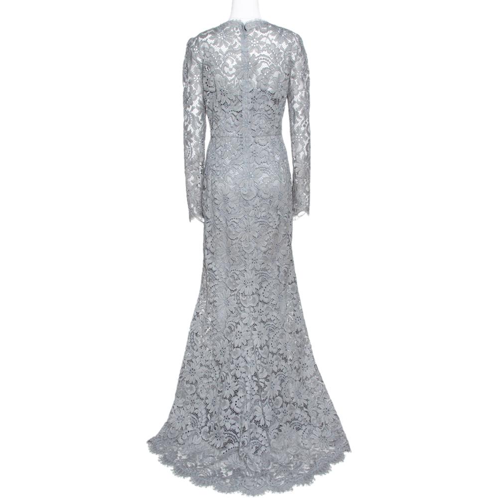 This maxi dress from Dolce & Gabbana is the perfect feminine outfit you would want to own. The beautiful grey piece is beautifully adorned with intricate corded lace. It features a lace hemline that touches the floor, long sleeves, fitted waistband