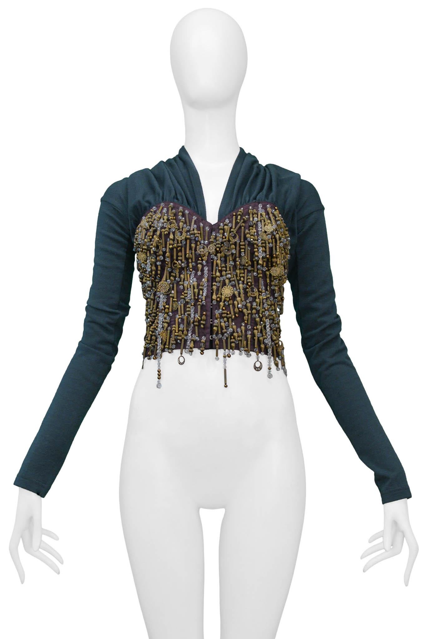 Resurrection Vintage is excited to offer a vintage Dolce & Gabbana grey-green beaded jacket featuring a front hook and eye closure, a gathered collar, and a brown bustier connected to the top covered in beads consisting of metal and crystal beads. 
