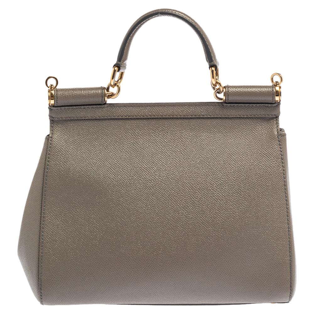 The iconic Miss Sicily bag by Dolce & Gabbana is named after Domenico Dolce's native land and exhibits the aesthetic of Italian glamour. The neat silhouette is made from leather in a grey shade and features a front flap accented with the signature