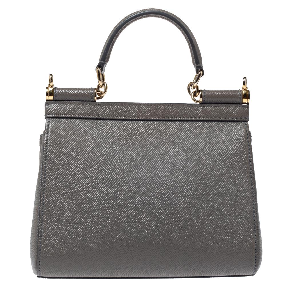 This gorgeous grey Miss Sicily satchel from Dolce & Gabbana is a handbag coveted by women around the world. It has a well-structured design and a flap that opens to a compartment with fabric lining and enough space to fit your essentials. The bag
