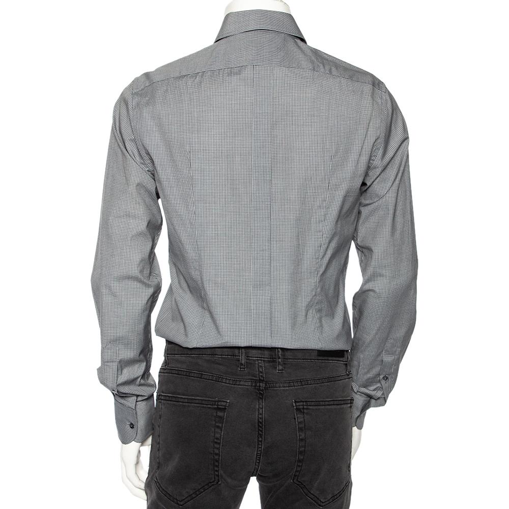 This grey-hued shirt from Dolce & Gabbana is comfortable to wear. The pin-checked shirt comes in cotton with a simple collar, front button fastening, and long sleeves. A pair of tailored trousers and leather shoes will complement the shirt well.

