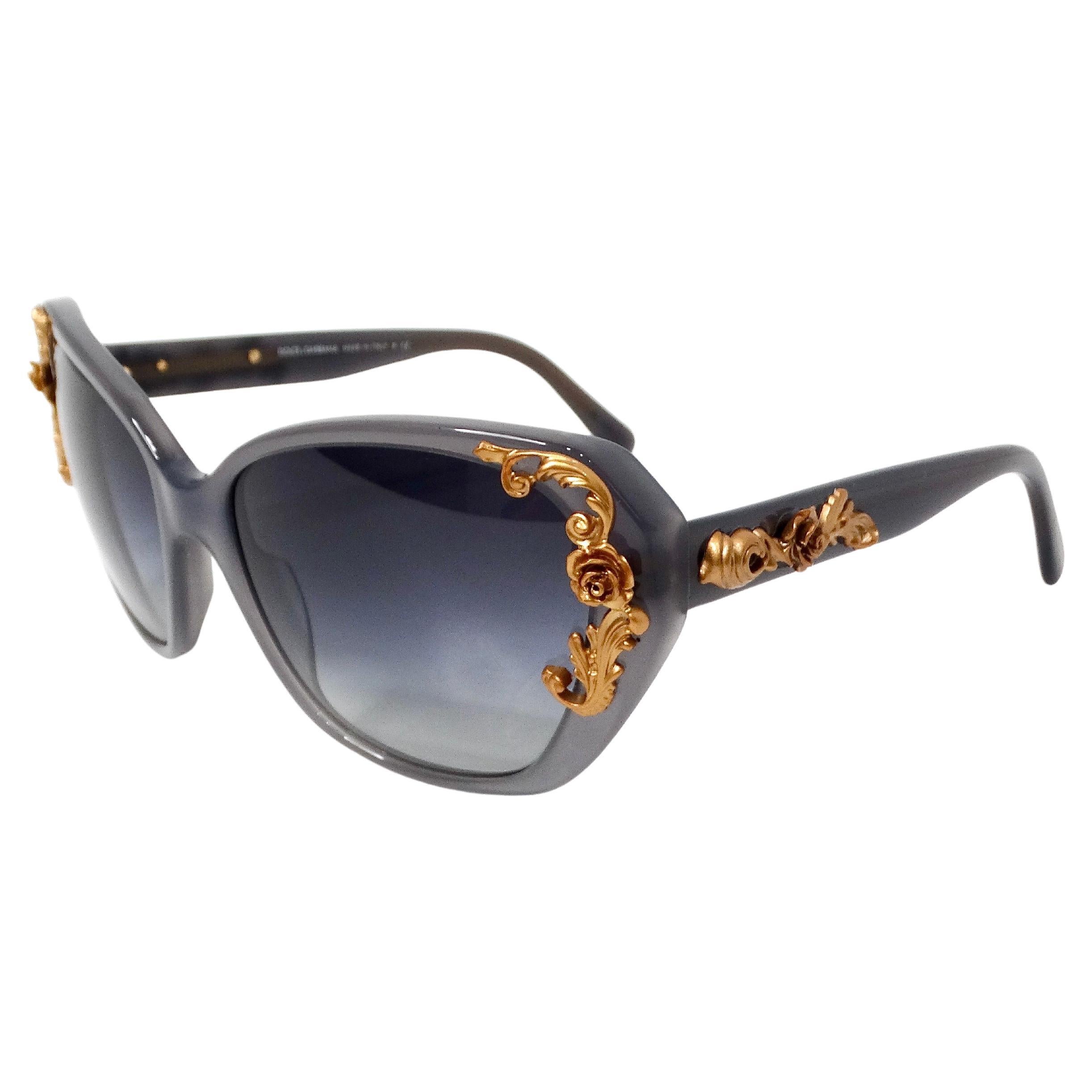 The Dolce & Gabbana Grey Sicilian Baroque Floral Butterfly Sunglasses are a stunning embodiment of luxurious Italian craftsmanship and opulent design. Crafted with a sophisticated grey tint, these sunglasses exude an air of understated elegance