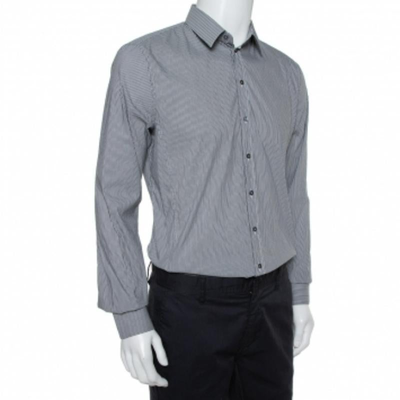 Look incredibly good at your business meetings by wearing this shirt from Dolce & Gabbana. Made from a cotton blend in a grey shade, it features a striped pattern all over, a classic collar, and a front button fastening. Wear the shirt with