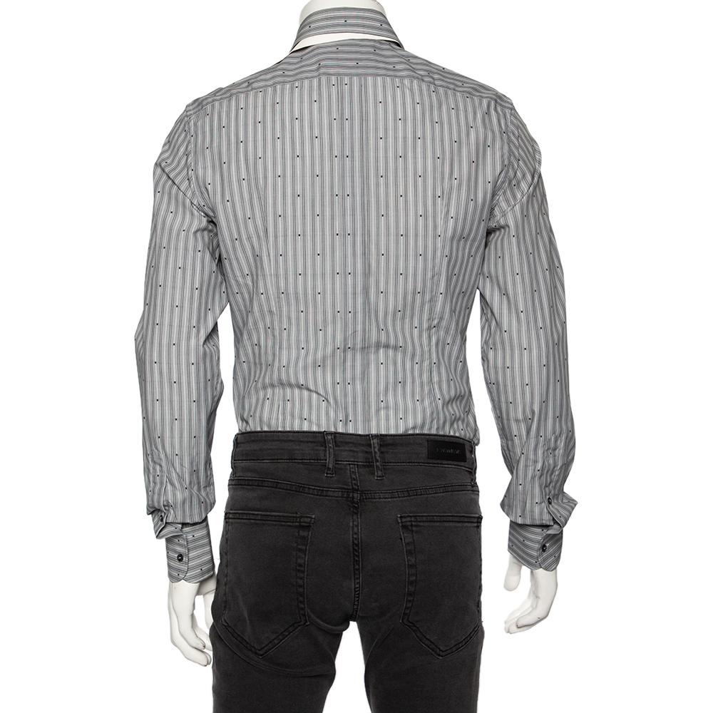A seamless blend of comfort, class, and style, this Dolce & Gabbana shirt is ideal for those office meetings and formal settings. Tailored from cotton in a grey shade, the creation is detailed with striped patterns all over, embroidery, cuffed long