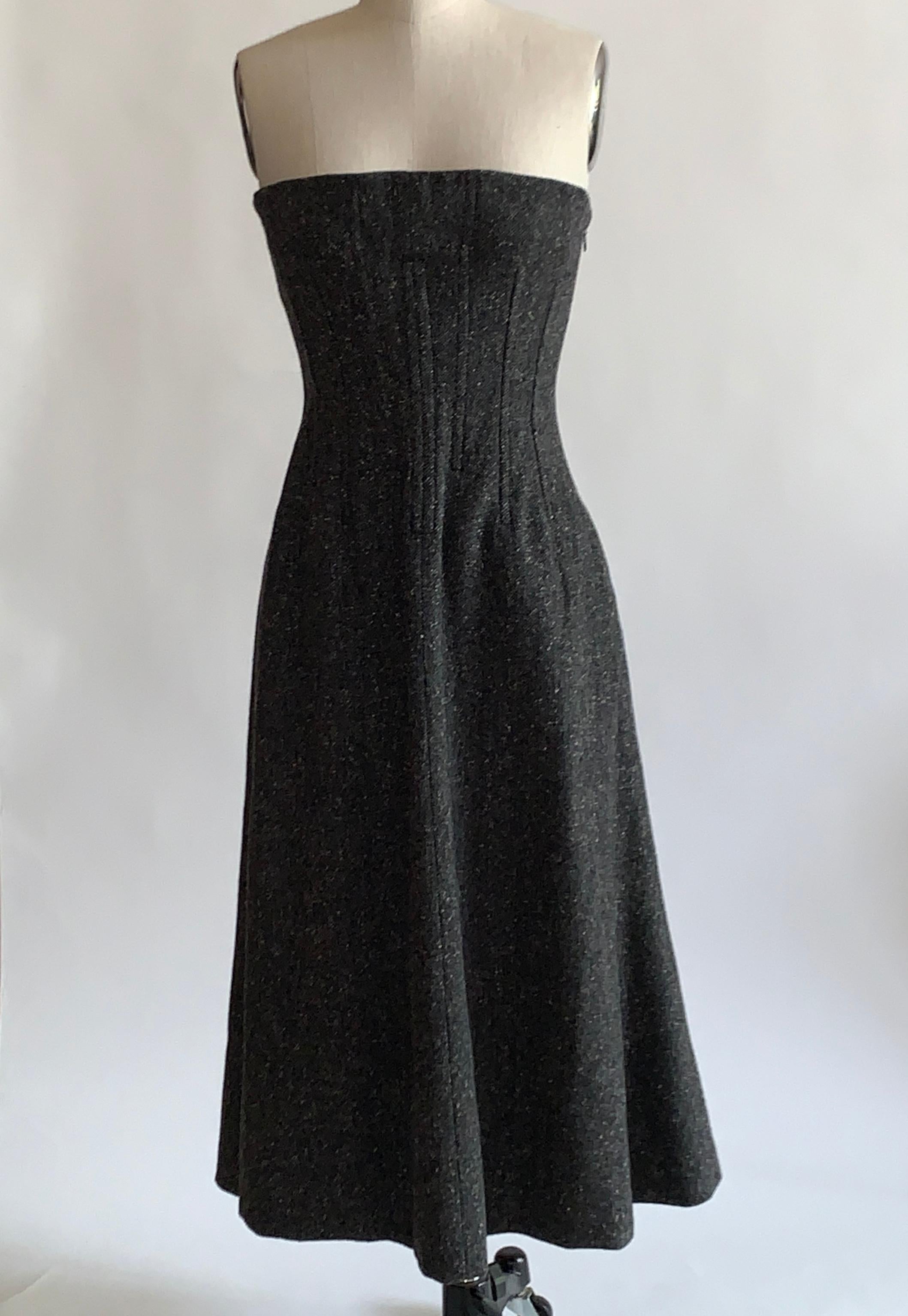 Dolce & Gabbana grey tweed strapless fit and flare dress with black corset seamed bodice and lace up detail at back. Side zip and hook and eye, boning at interior bodice for shape & structure.

Very sexy on it's own, but would also be cool layered