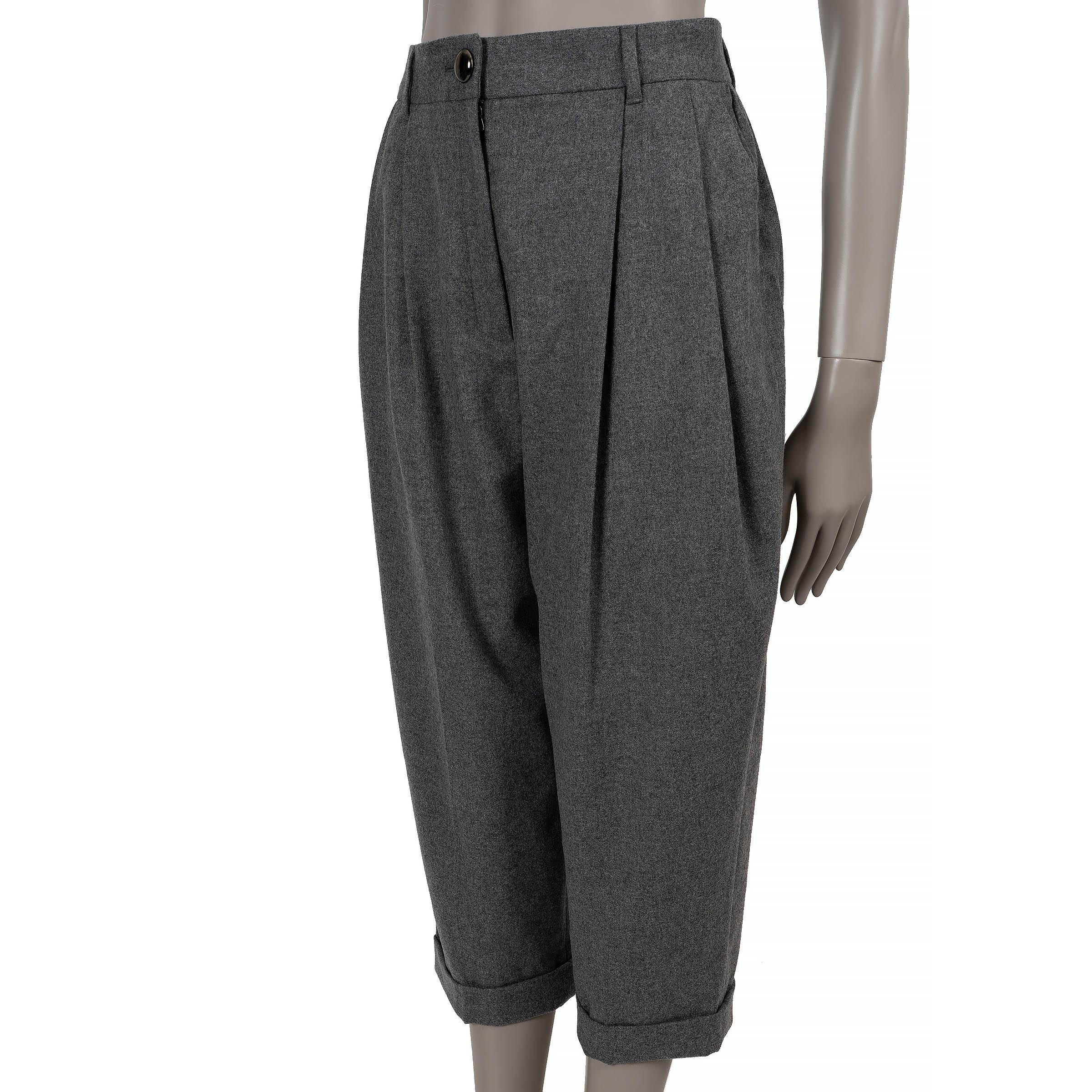 This 100% authentic Dolce & Gabbana pants in grey wool (90%) and cashmere (10%) offer a refined take on classic tailoring. Designed with a high-waisted silhouette and cropped legs, they feature front pleats and discreet slit pockets for a polished