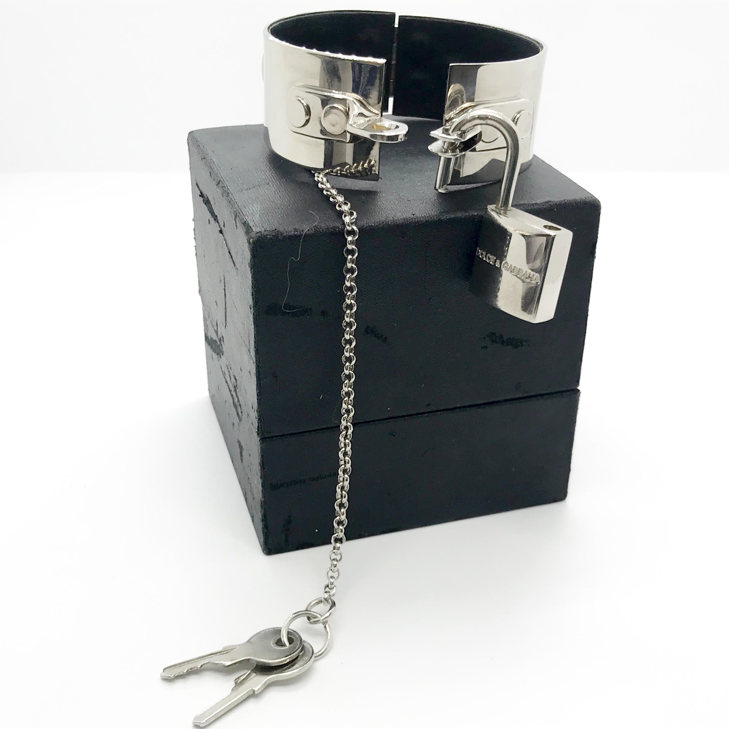 Dolce & Gabbana 1999 Bondage Handcuff Runway Bracelet

From the bondage collection 1999.  A real collectors item.

Silver metal with black leather on the inside. Comes with two keys and original box. 

Small-medium size - Women’s. 

