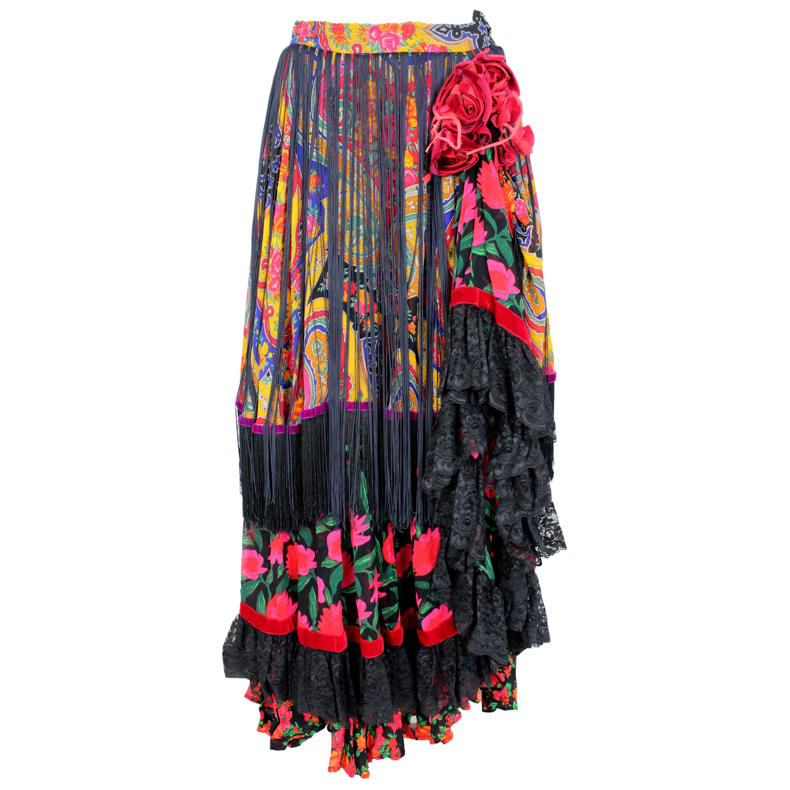 This is an exquisite Dolce & Gabbana skirt from the 2000s haute couture collection. The skirt is crafted from a delicate tulle fabric, featuring an all-over floral print, fringes, and lace detailing. The colors in the floral print are warm and