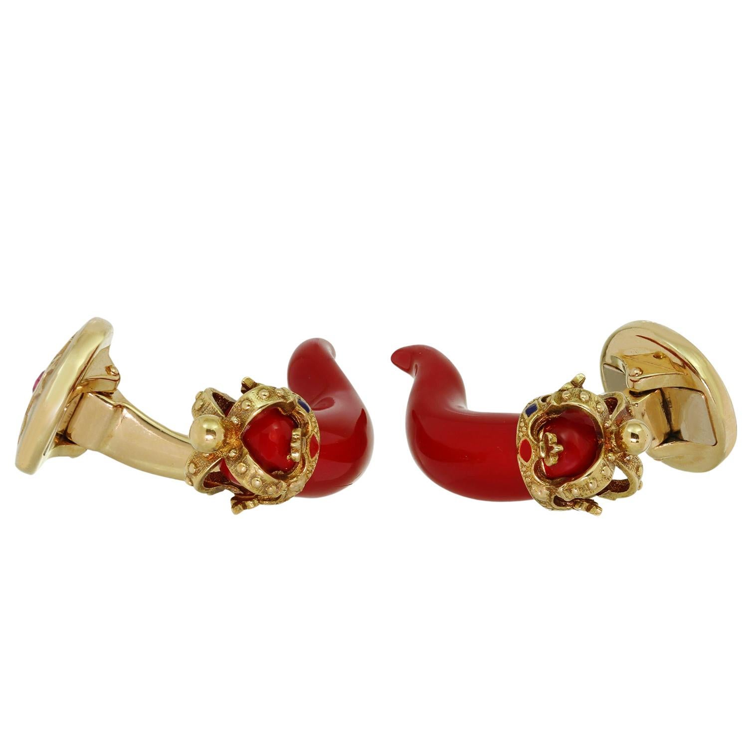 Diese wunderschönen Manschettenknöpfe von Dolce & Gabbana sind aus 18-karätigem Gelbgold gefertigt und zeigen rote Horn-Amulette aus Emaille mit goldenen Kronen, die mit emaillierten Motiven und roten Rubinen von schätzungsweise 0,09 Karat verziert