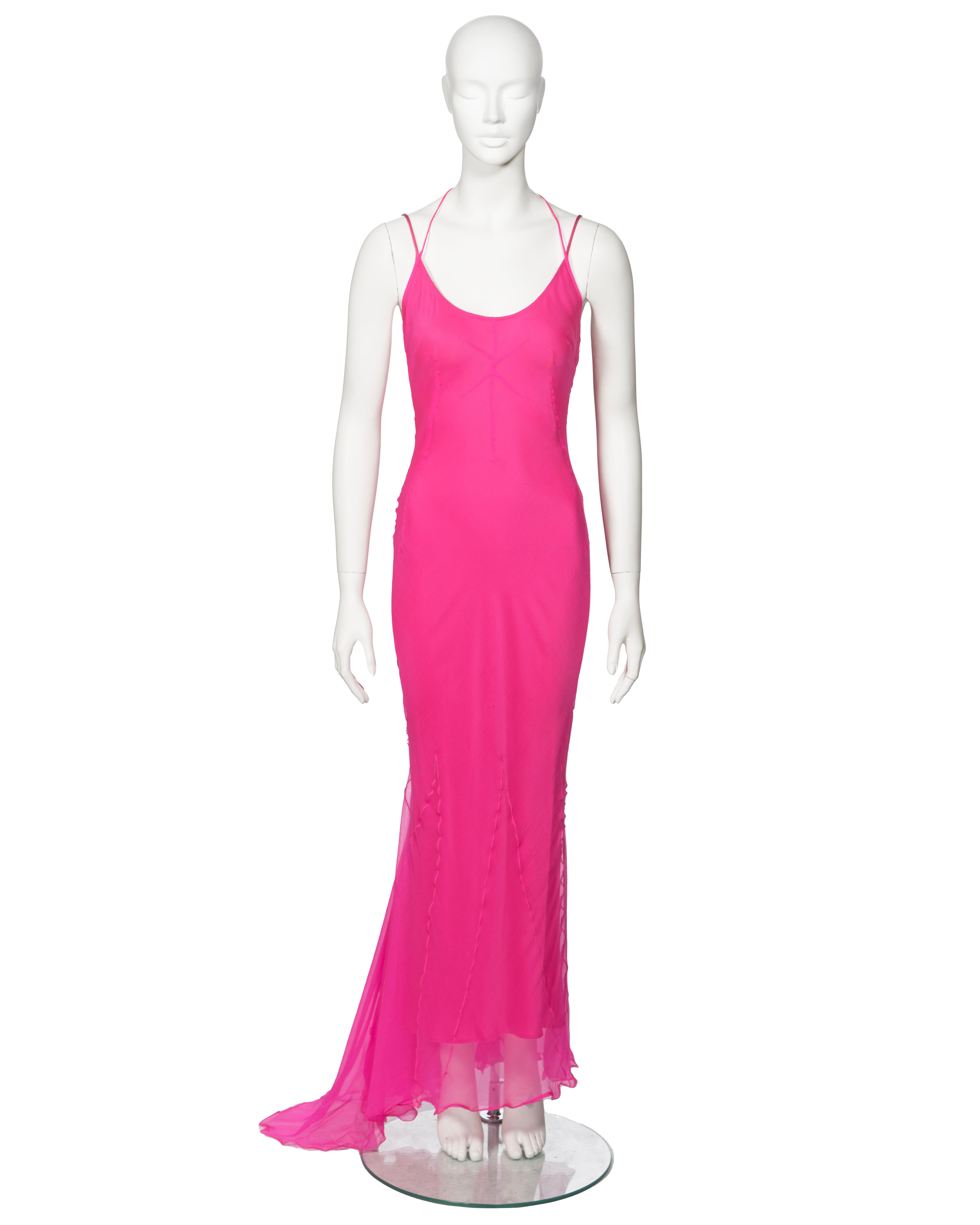 ▪ Archival Dolce & Gabbana Evening Dress
▪ Fall-Winter 2000
▪ Sold by One of a Kind Archive
▪ Crafted from bias-cut hot pink crinkled silk chiffon
▪ Halter neck ties 
▪ Integrated slip dress silk lining with spaghetti straps
▪ Floor-length skirt
