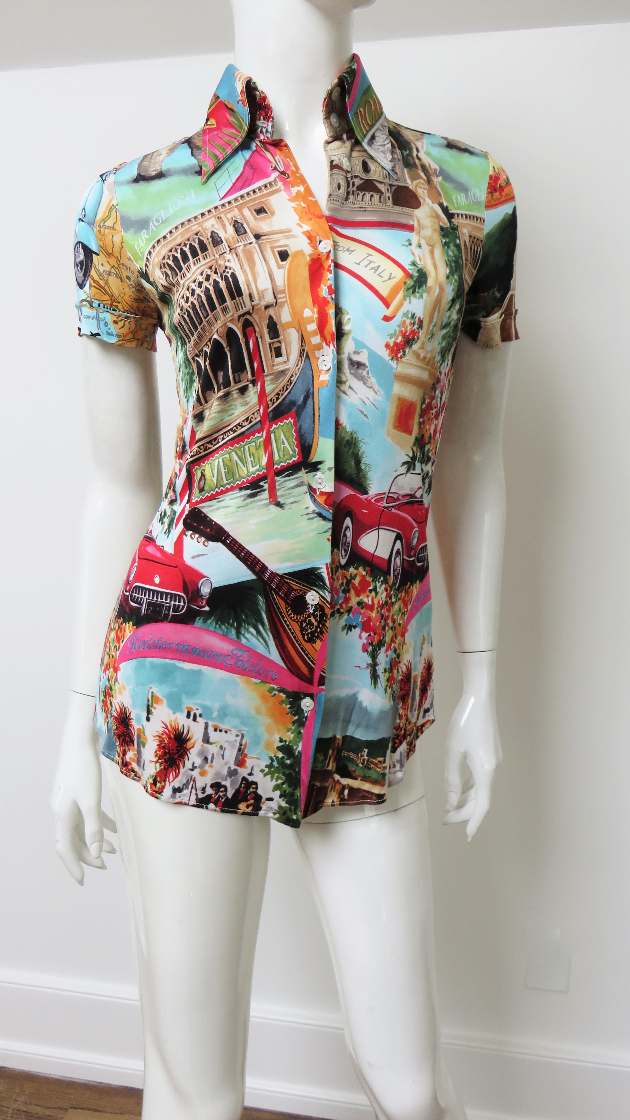 A fabulous fine silk stretch short sleeve shirt in bright colors depicting Italian scenes and words from Dolce & Gabbana. It has a shirt collar, a back yoke and a Dolce & Gabbana inscribed mother of pearl button front closure.  It is covered in