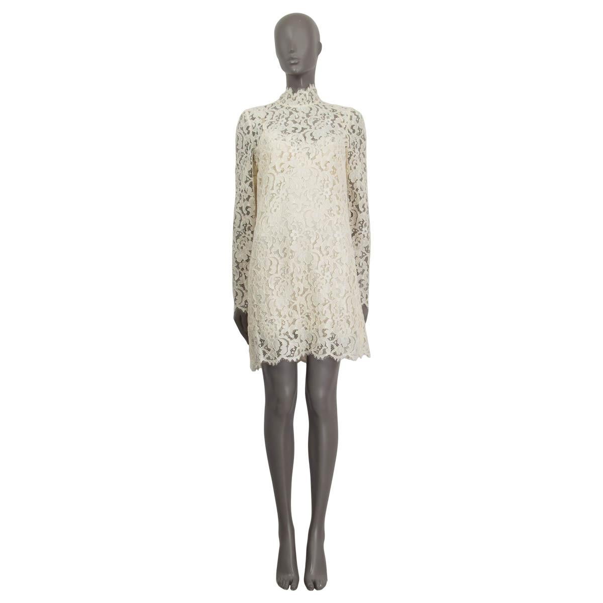 100% authentic Dolce&Gabbana long sleeve dress in off-white codonnet lace (viscose 80% and polyamide 20% - please note the content tag is missing). Features a high neck and a silk-blend slip dress. Opens with three push buttons and a concealed