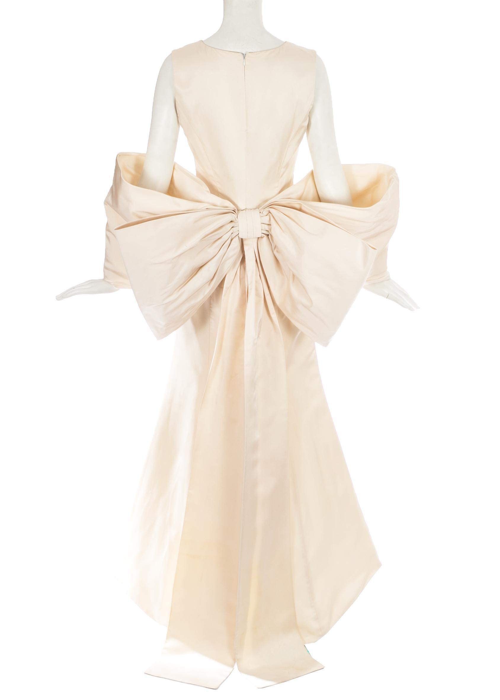 Dolce & Gabbana ivory silk fishtail wedding dress with large bow at rear

c. 1990s